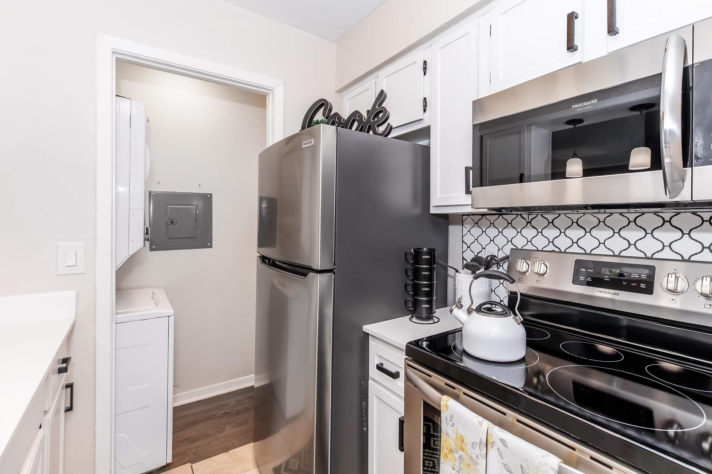 a kitchen with a stove sink and refrigerator