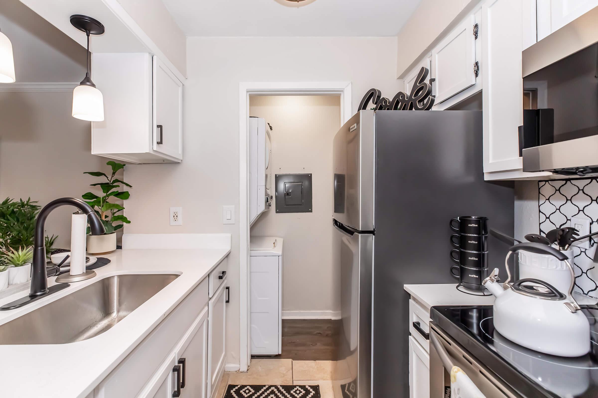 a kitchen with a sink and a mirror