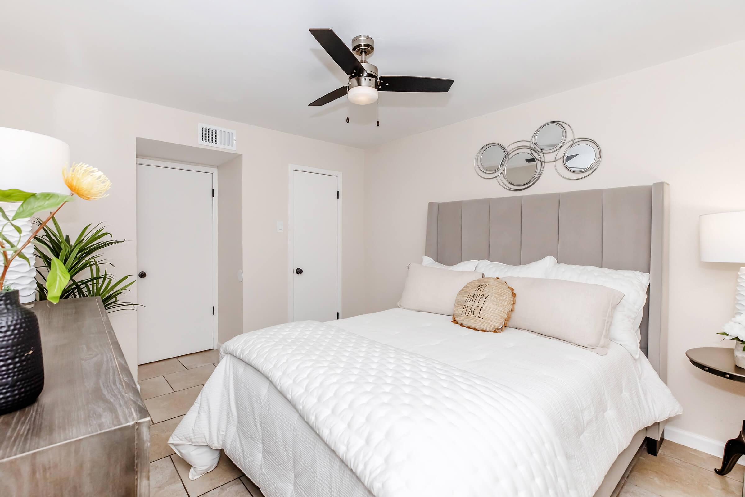 a bedroom with a bed and desk in a room