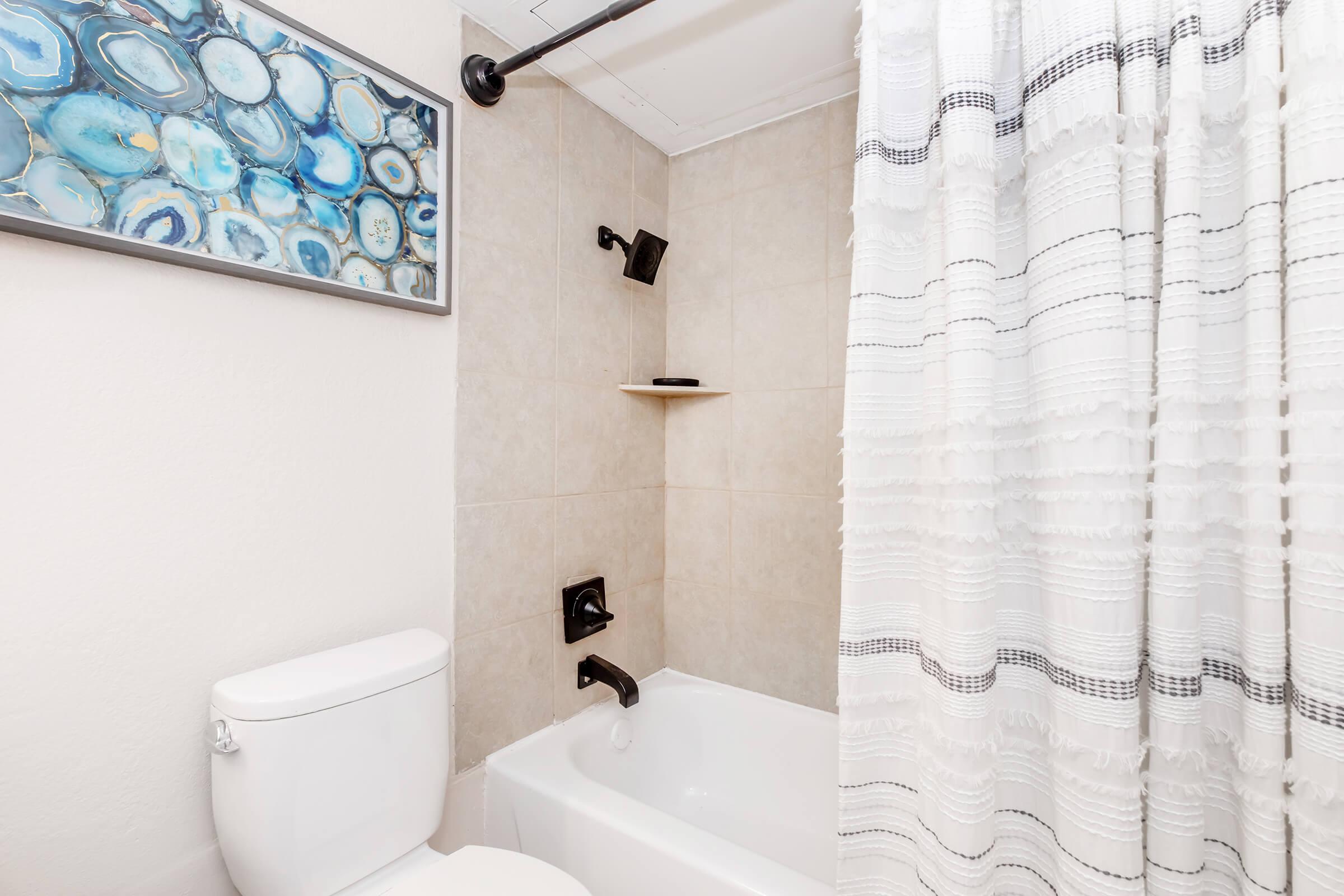 a shower curtain next to a sink