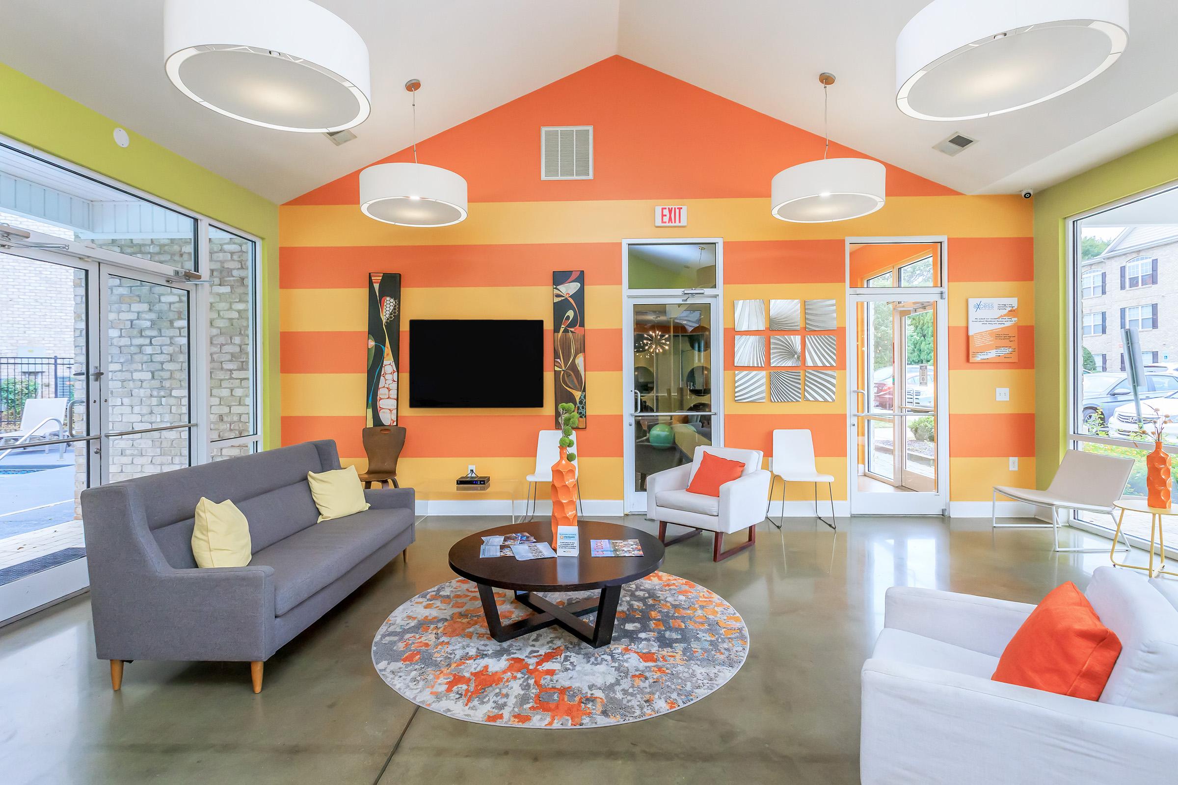 a living room filled with furniture and a flat screen tv