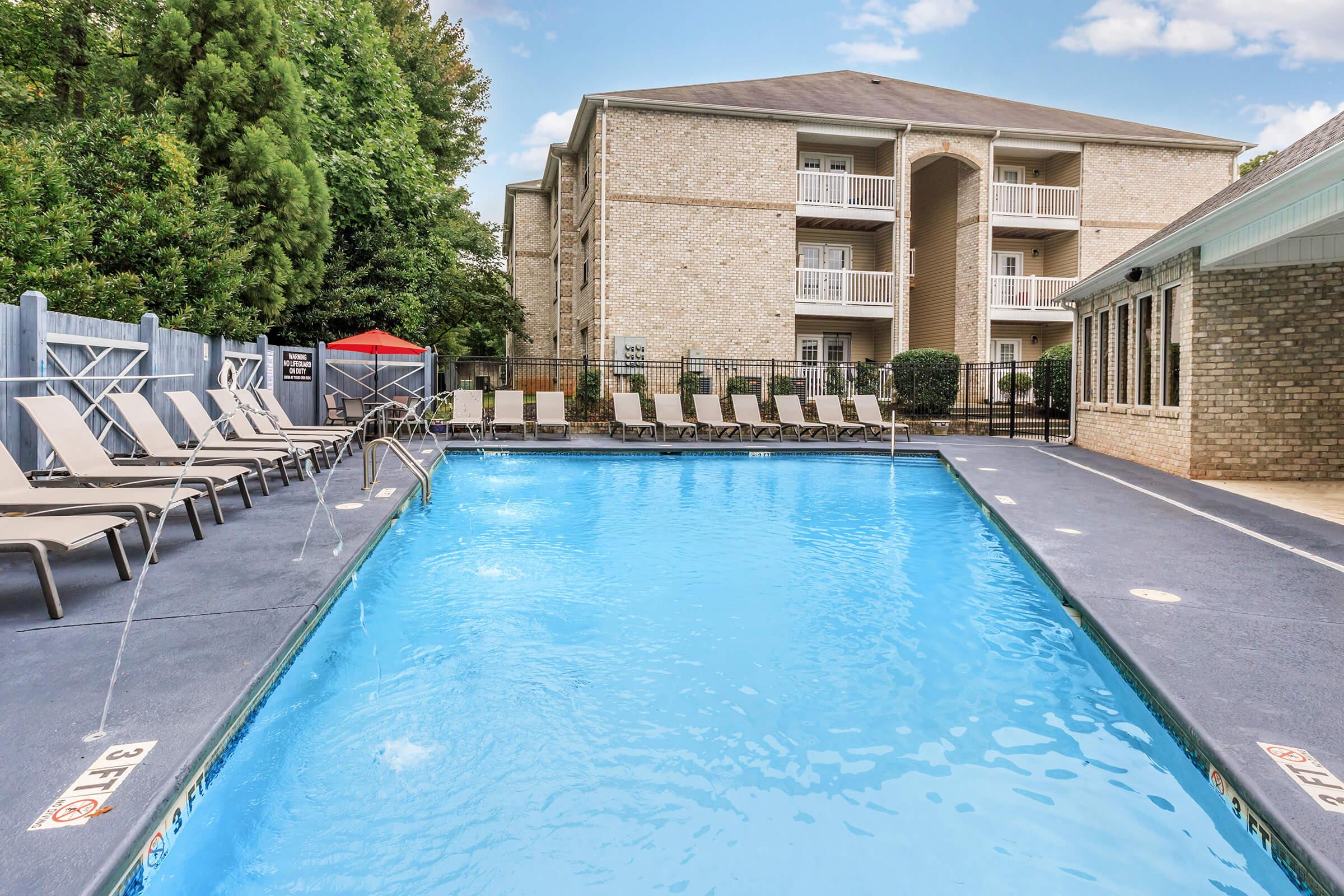 a house with a pool outside of a building