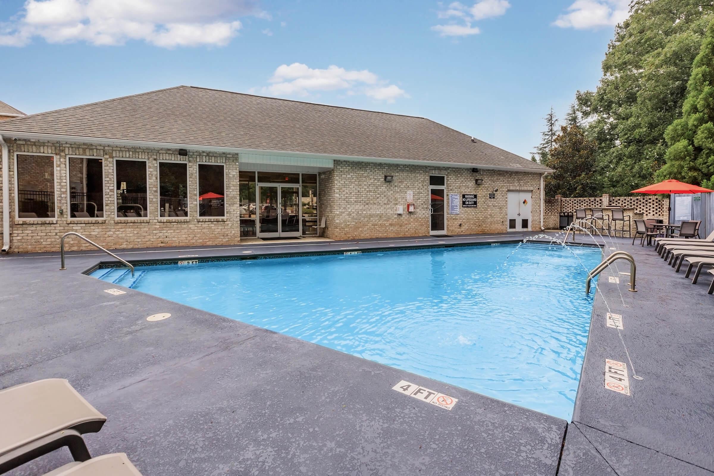 a house with a pool outside of a building