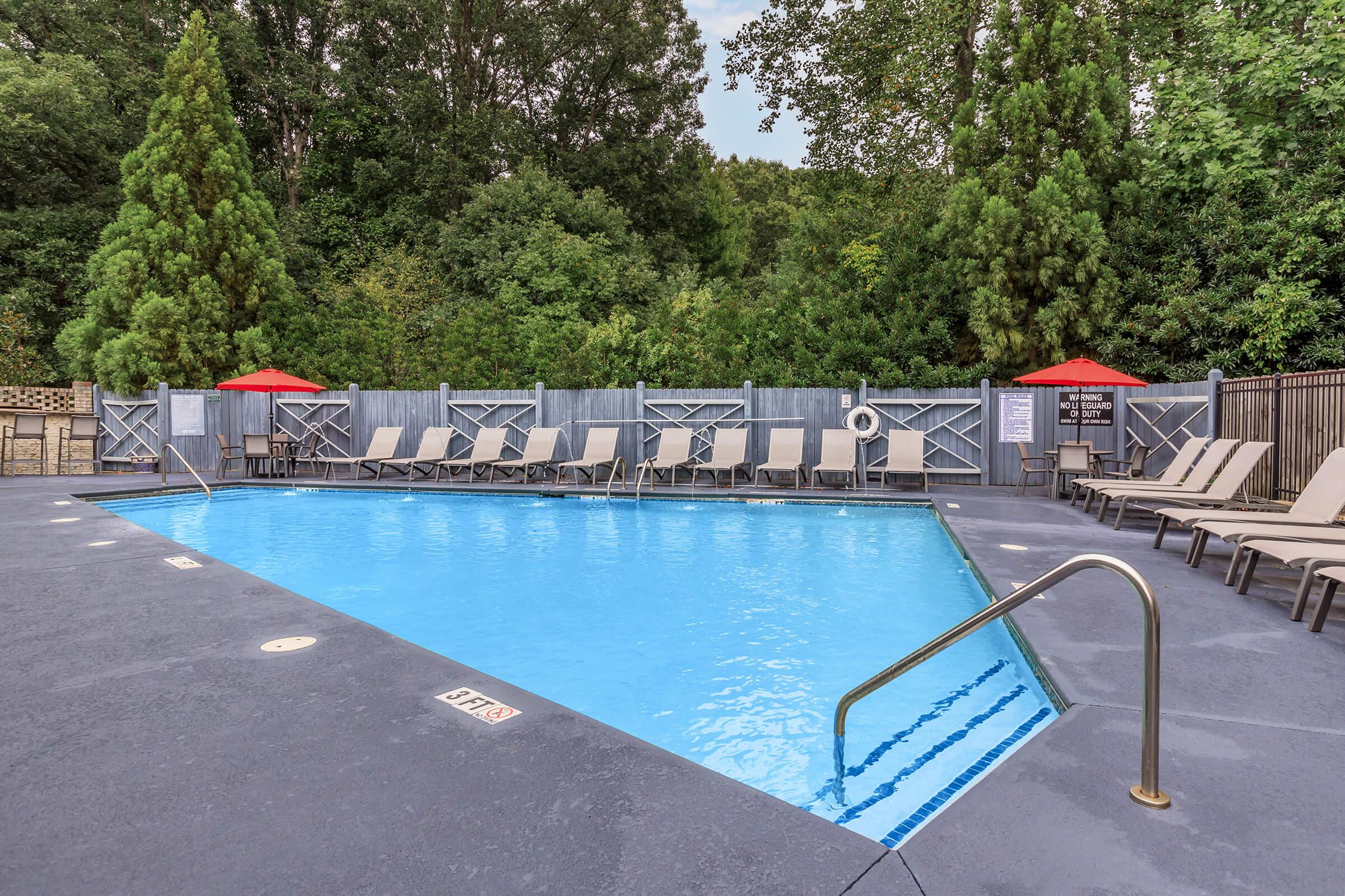 a bench next to a pool of water