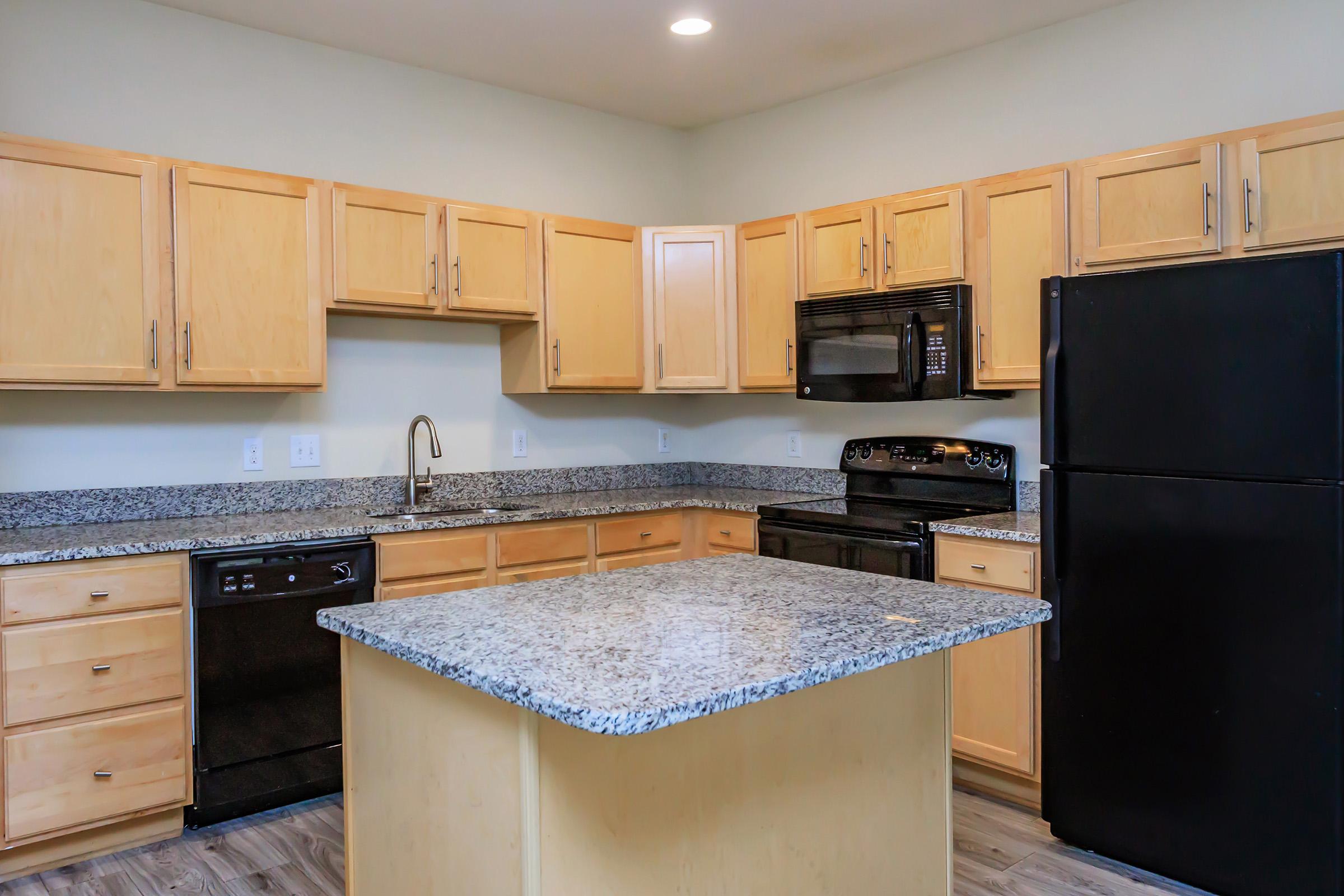 a kitchen with stainless steel appliances and wooden cabinets