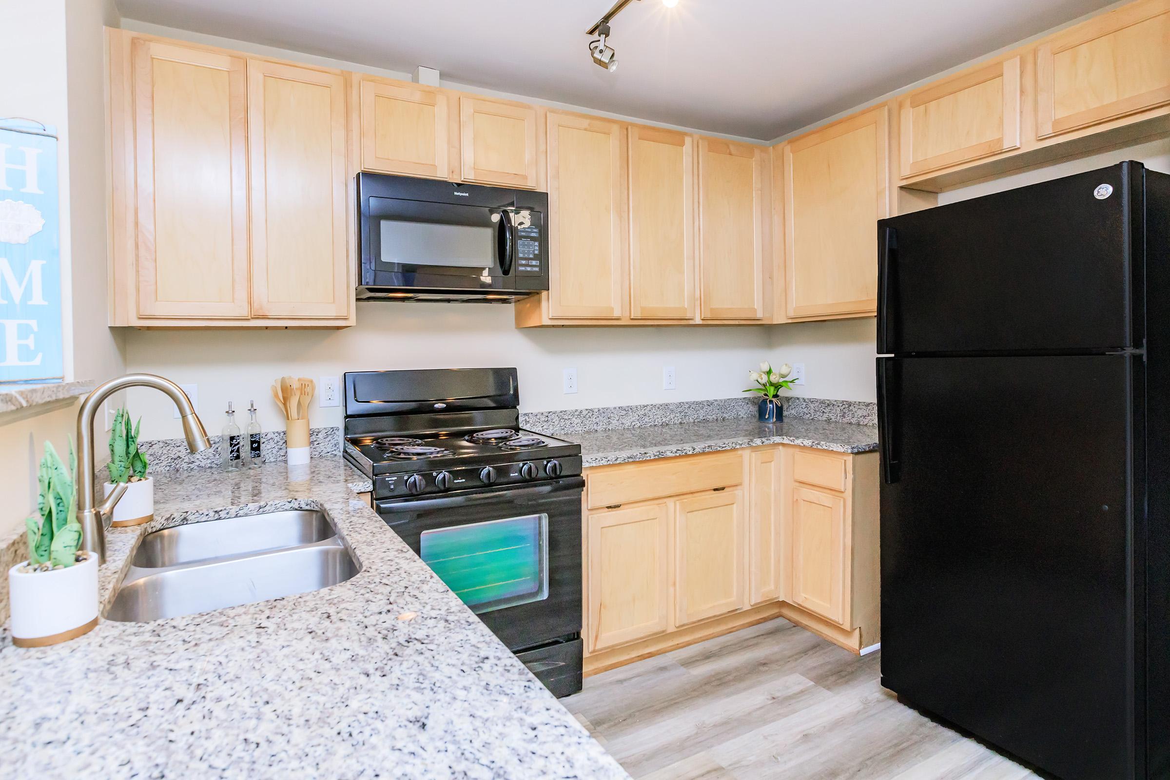 a kitchen with a stove a sink and a microwave