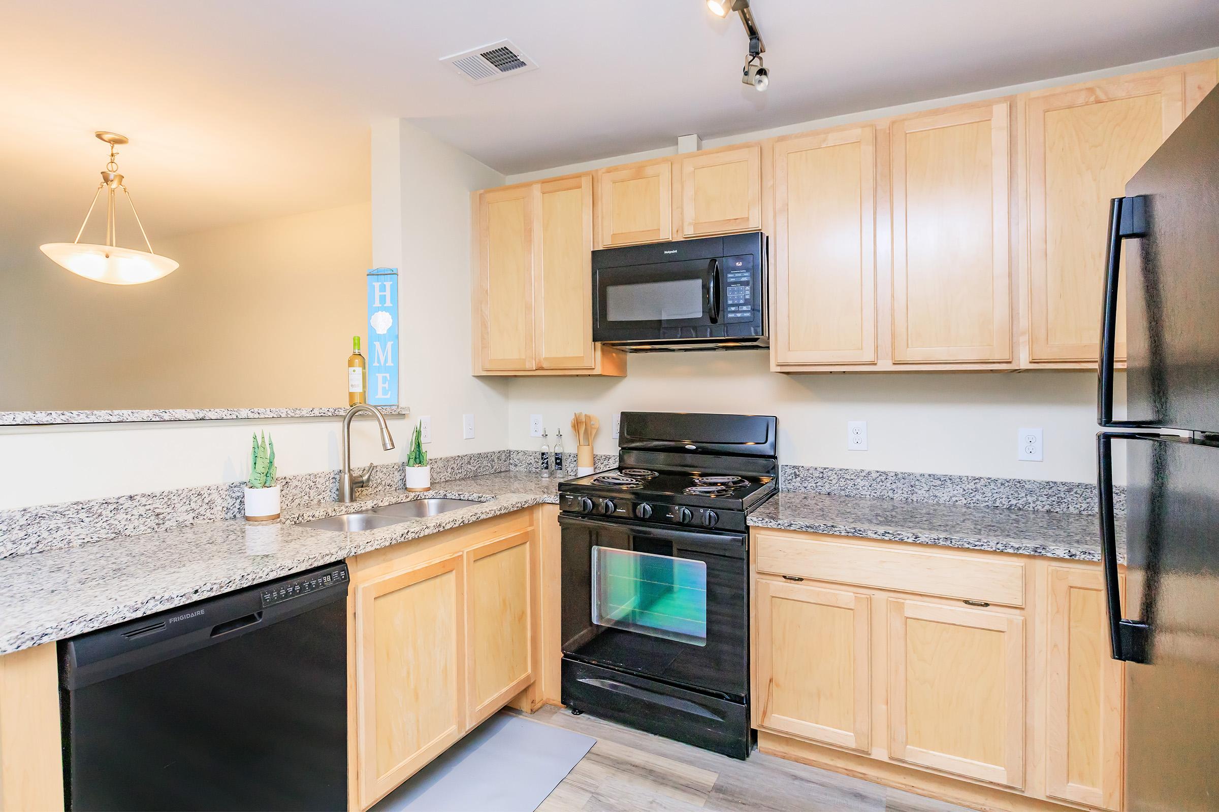 a modern kitchen with stainless steel appliances and wooden cabinets