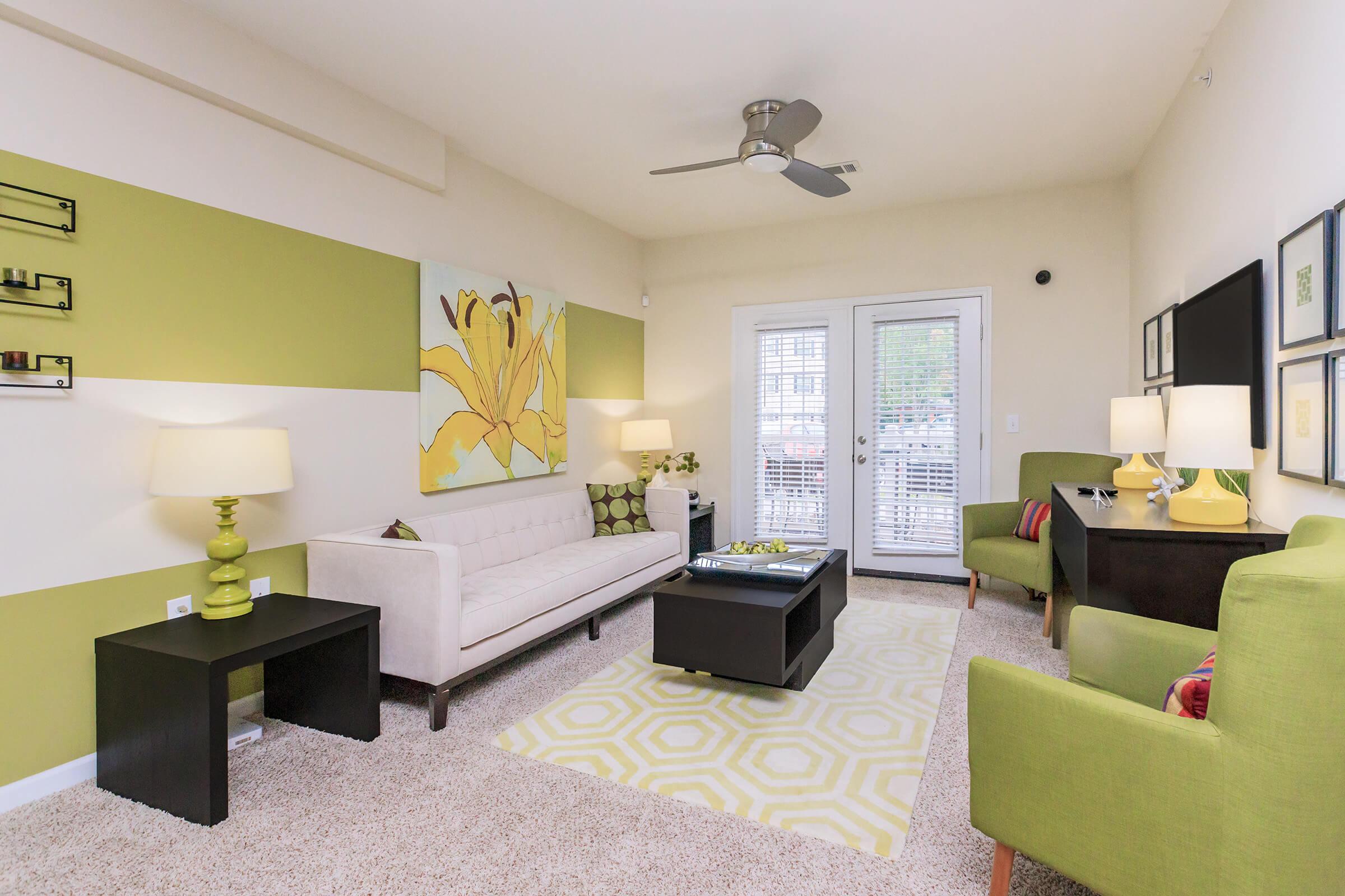 a living room filled with furniture and a flat screen tv