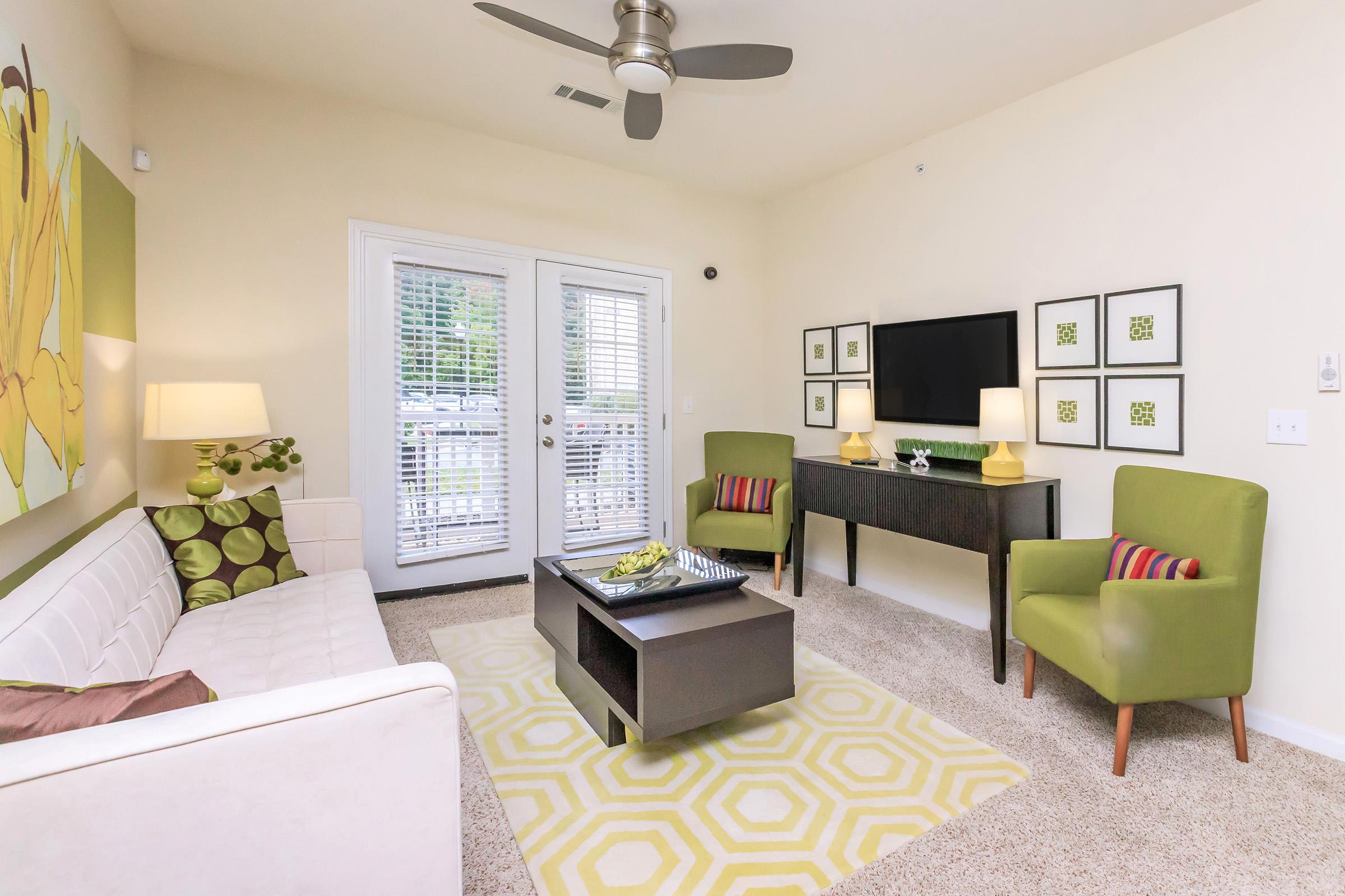 a living room filled with furniture and a table