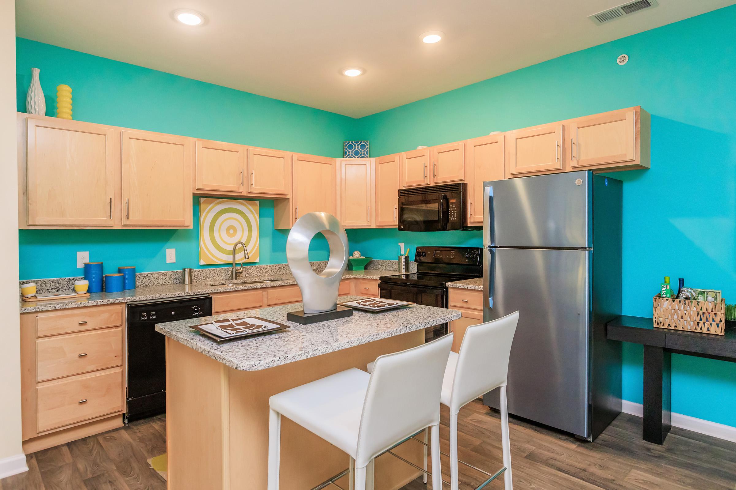 a kitchen with green walls