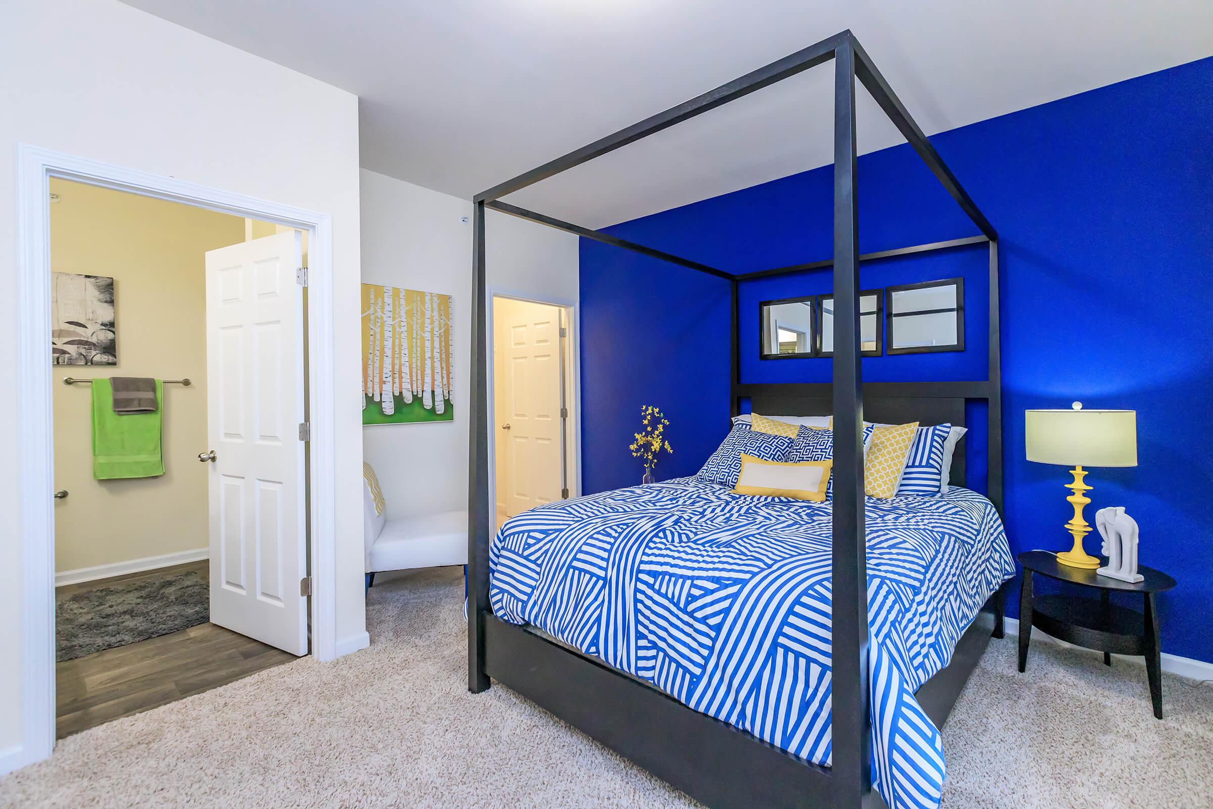 a bedroom with a blue chair