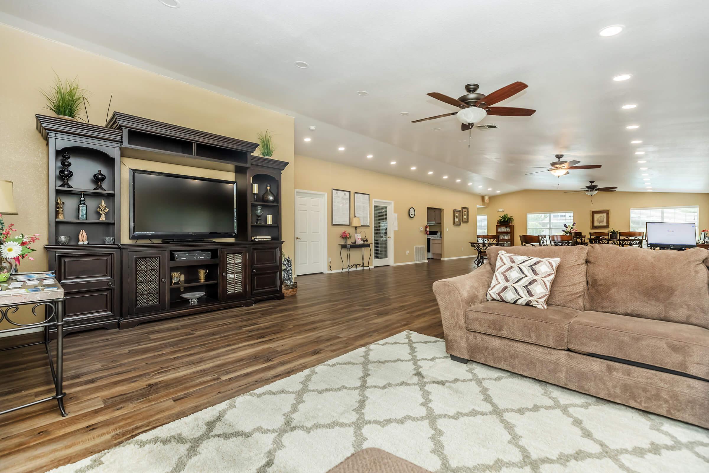 a living room filled with furniture and a tv