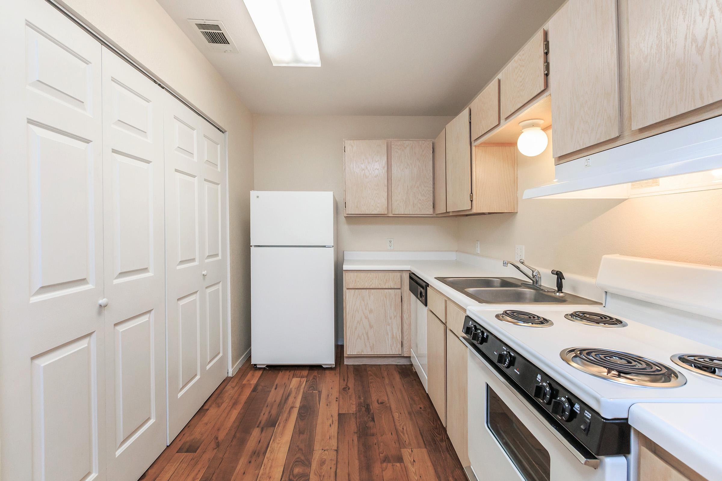 a white stove top oven sitting inside of a kitchen
