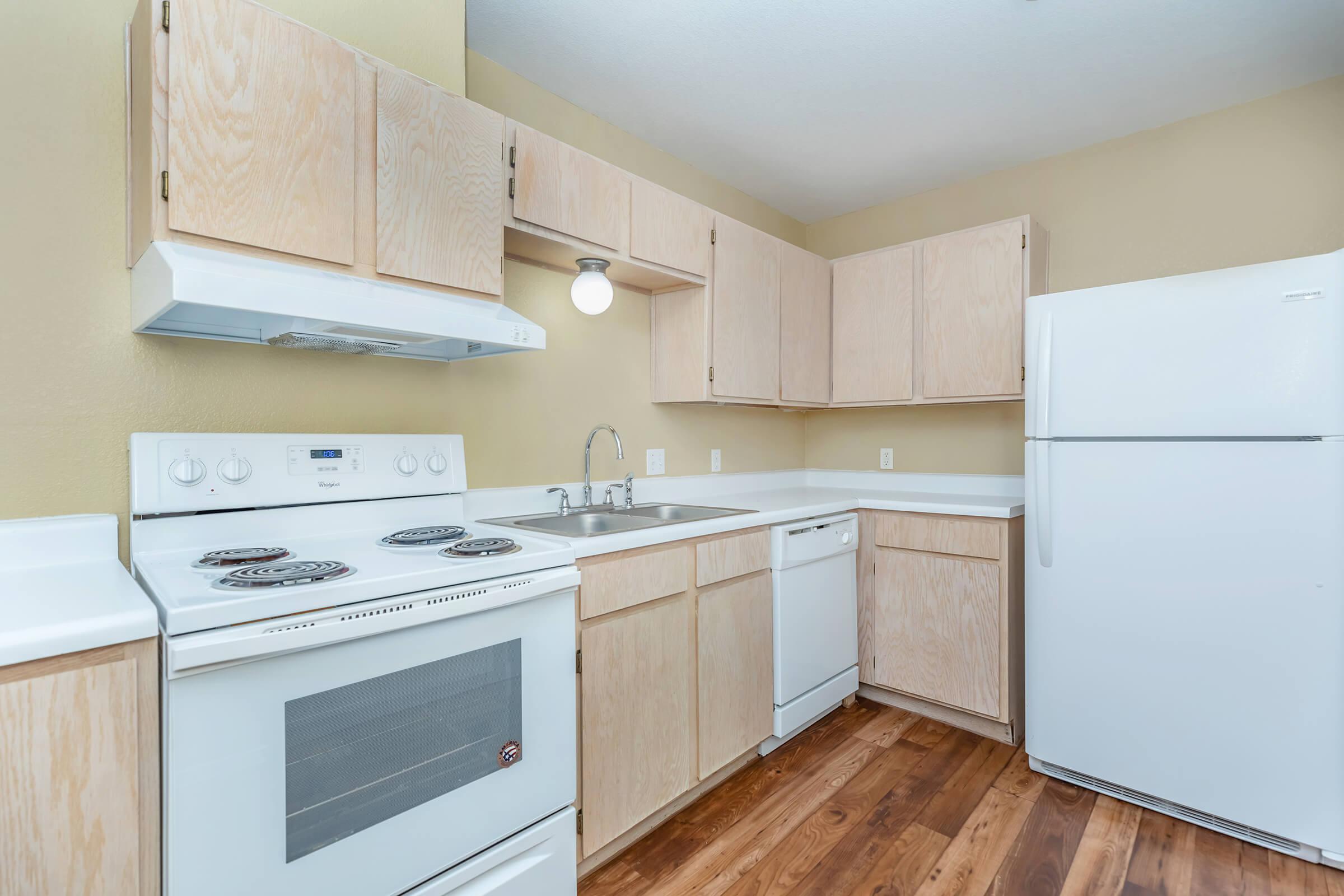 a kitchen with a stove and a refrigerator