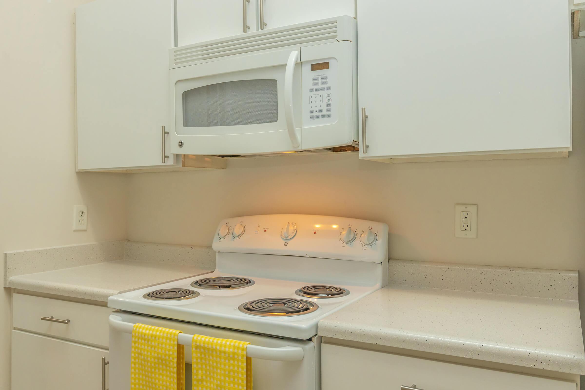 a microwave oven sitting on top of a stove