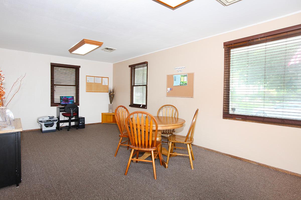 a living room filled with furniture and a large window