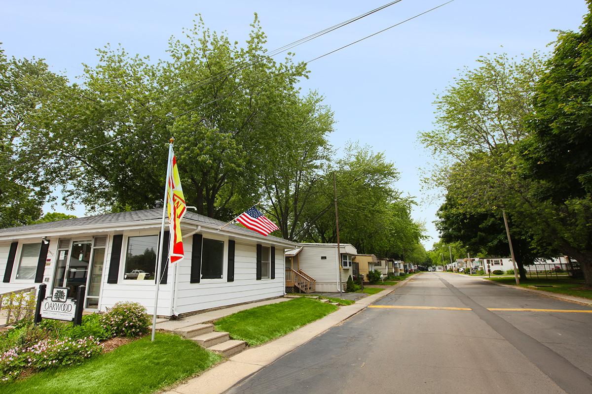 a house that has a sign on the side of a road