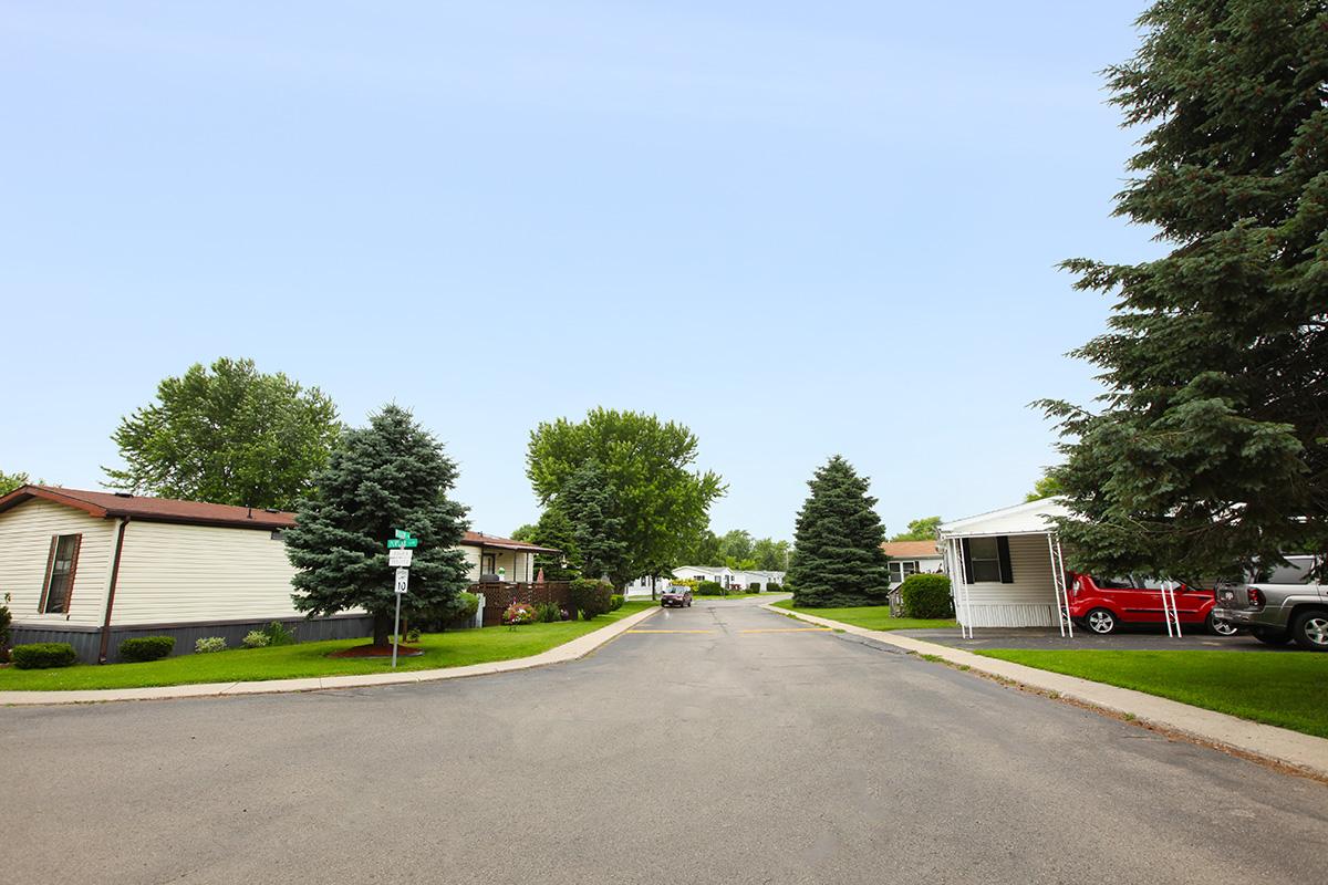 a house that has a sign on the side of a road