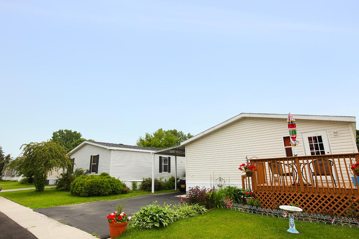 a large brick building with grass in front of a house