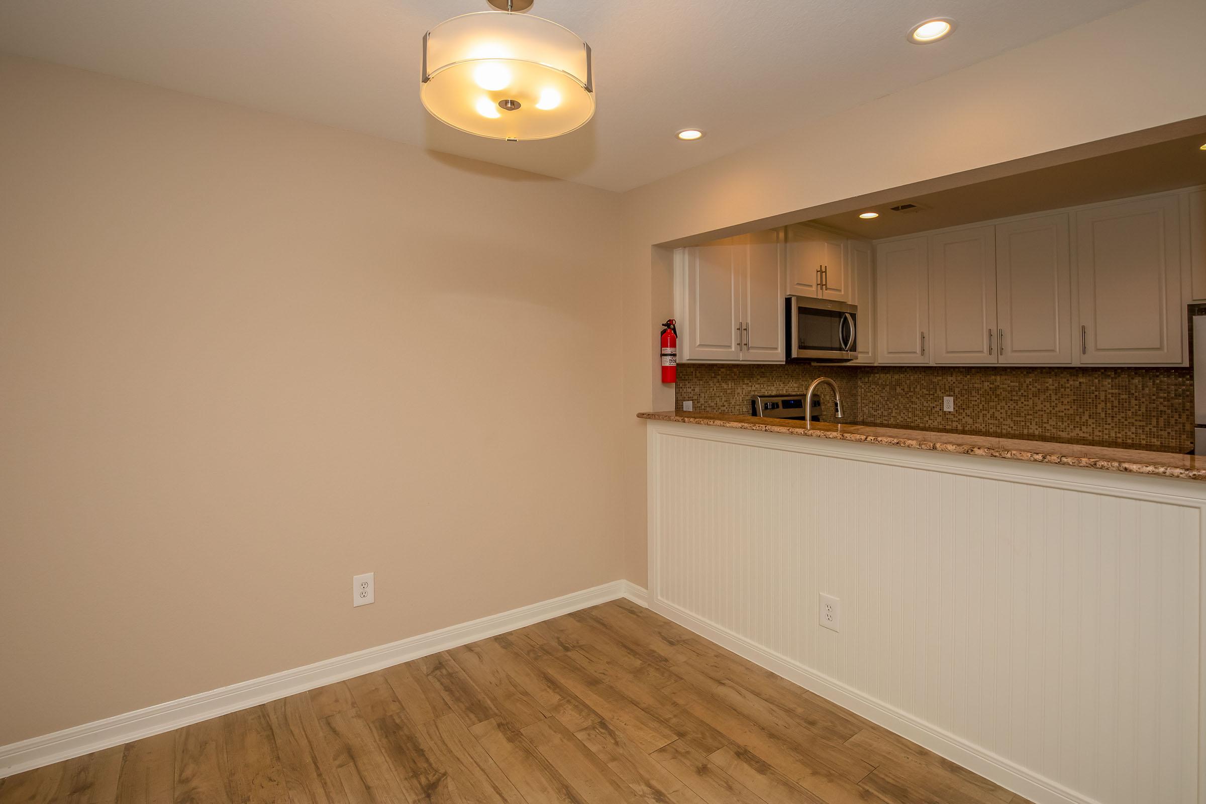 a kitchen with a sink and a mirror