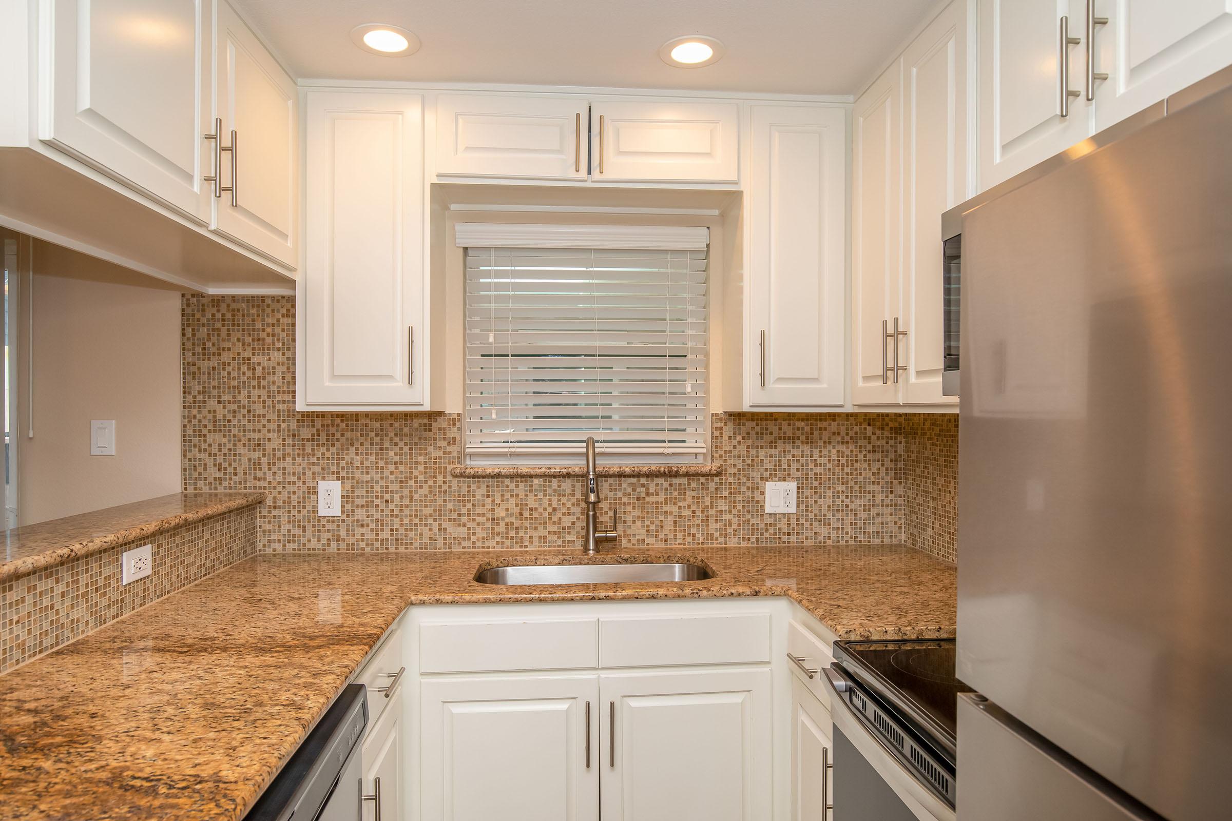 a kitchen with a sink and a window