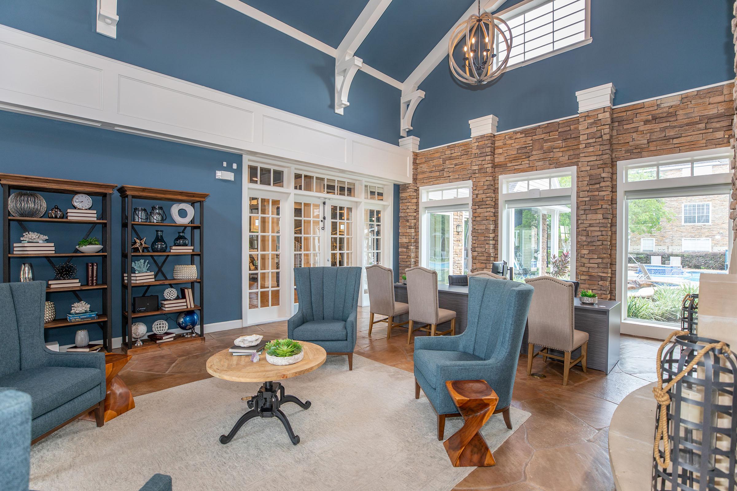 a living room filled with furniture and a large window