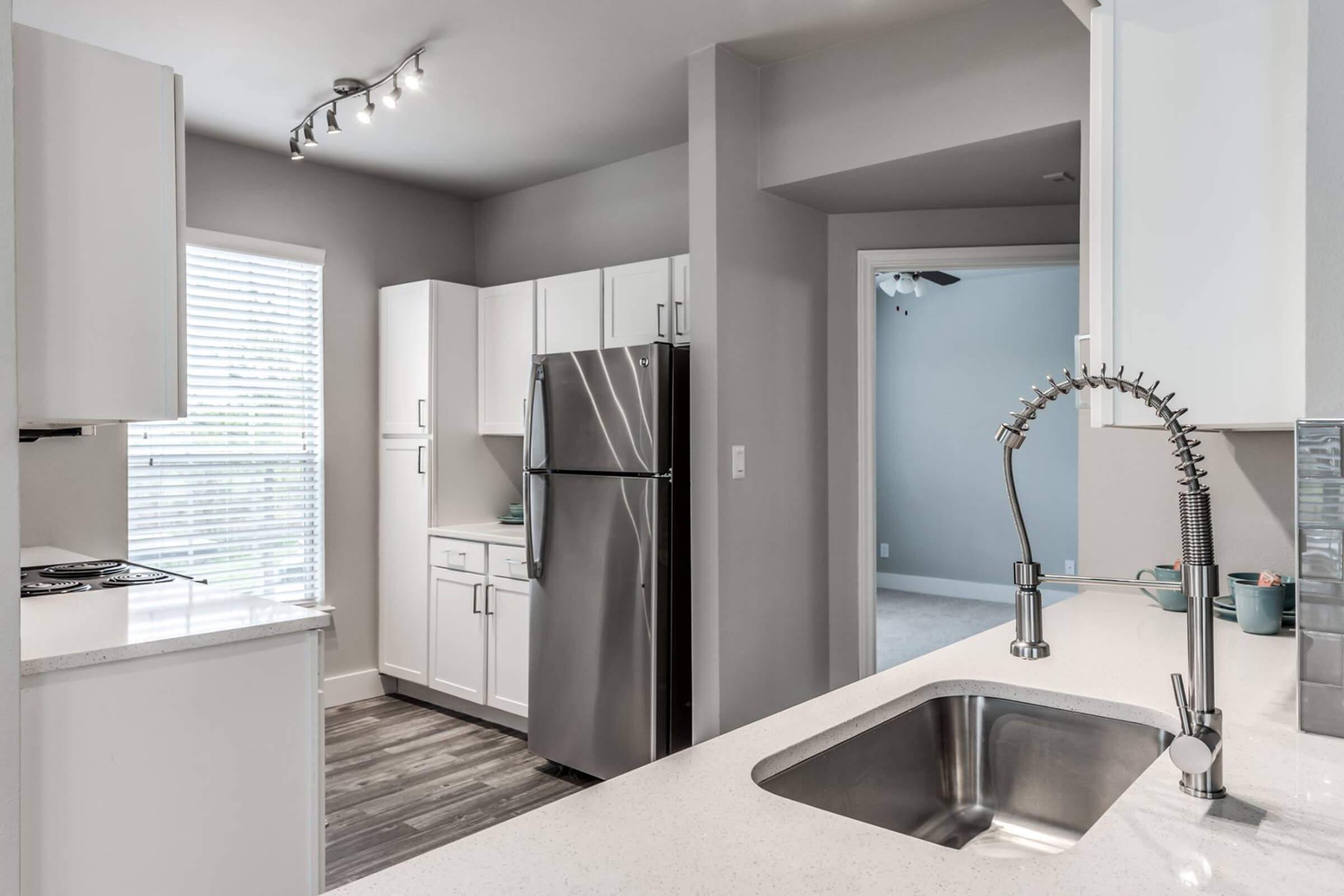 a kitchen with a sink and a mirror