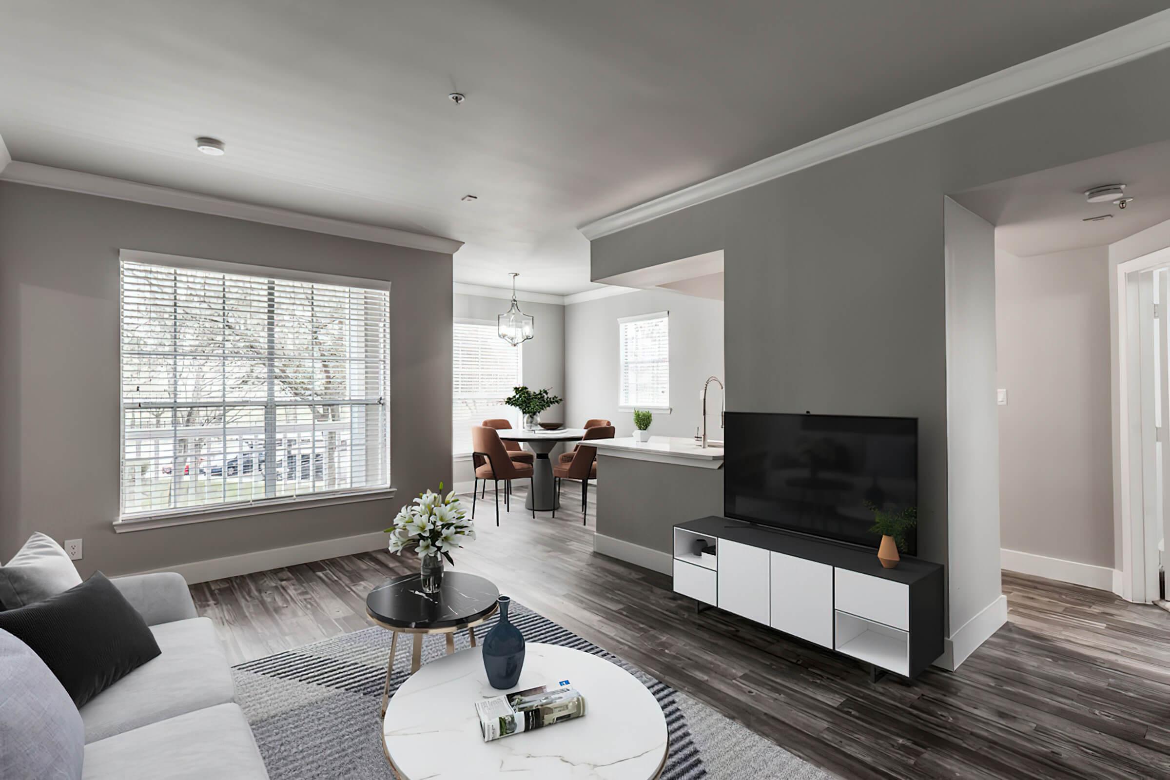 a living room filled with furniture and a large window