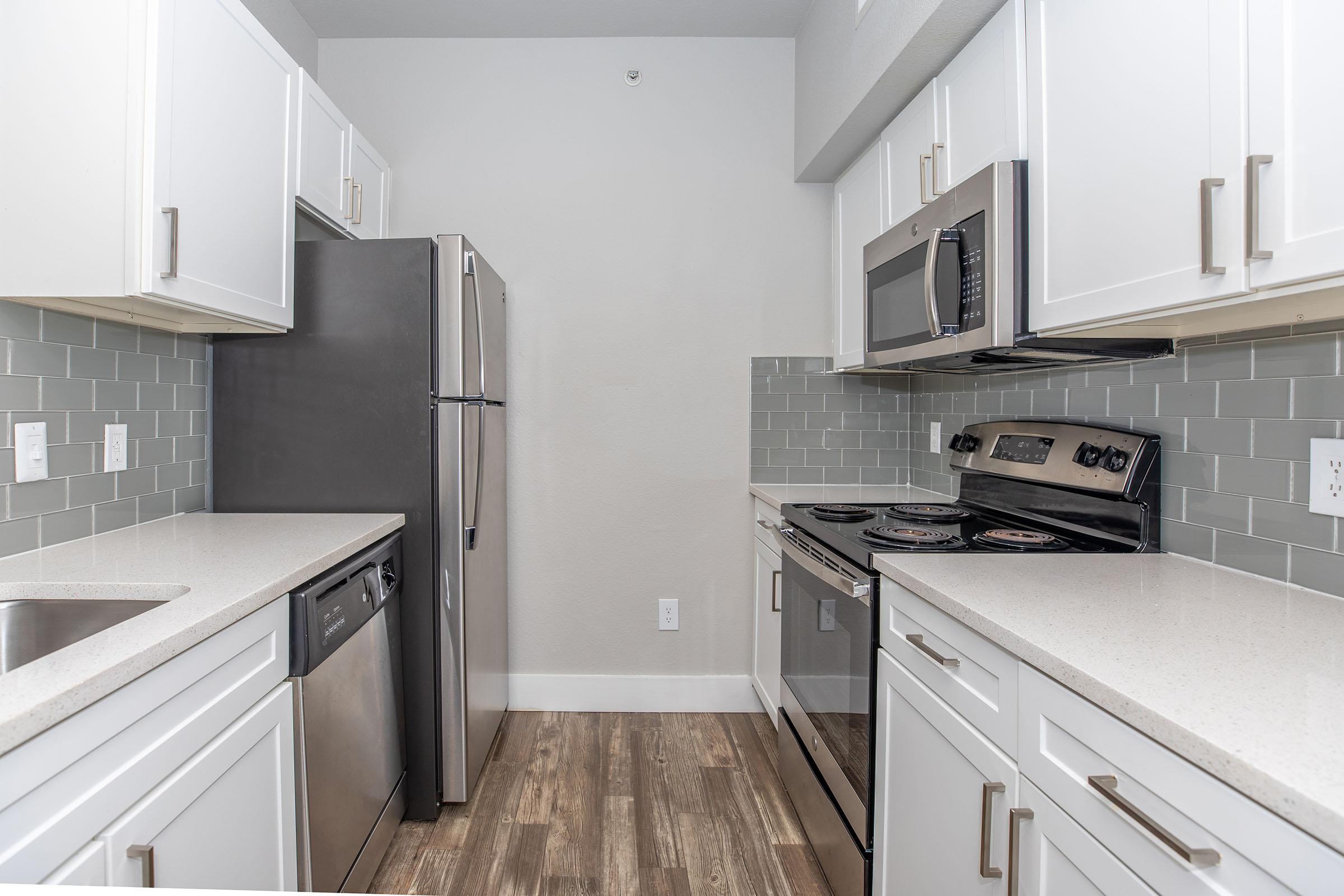 a kitchen with a stove sink and refrigerator