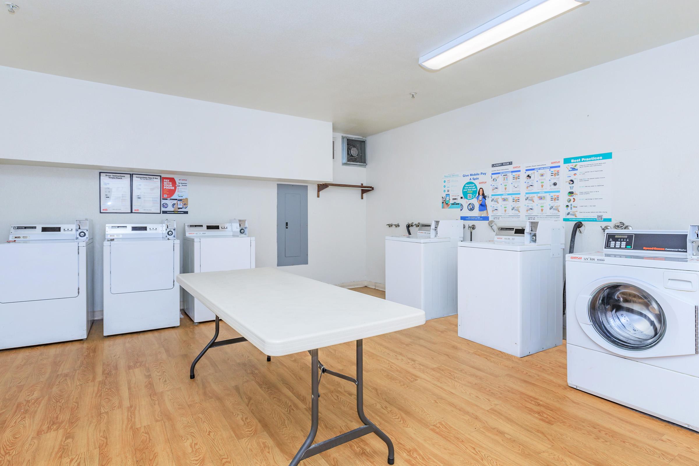 a kitchen with a refrigerator and table in a room