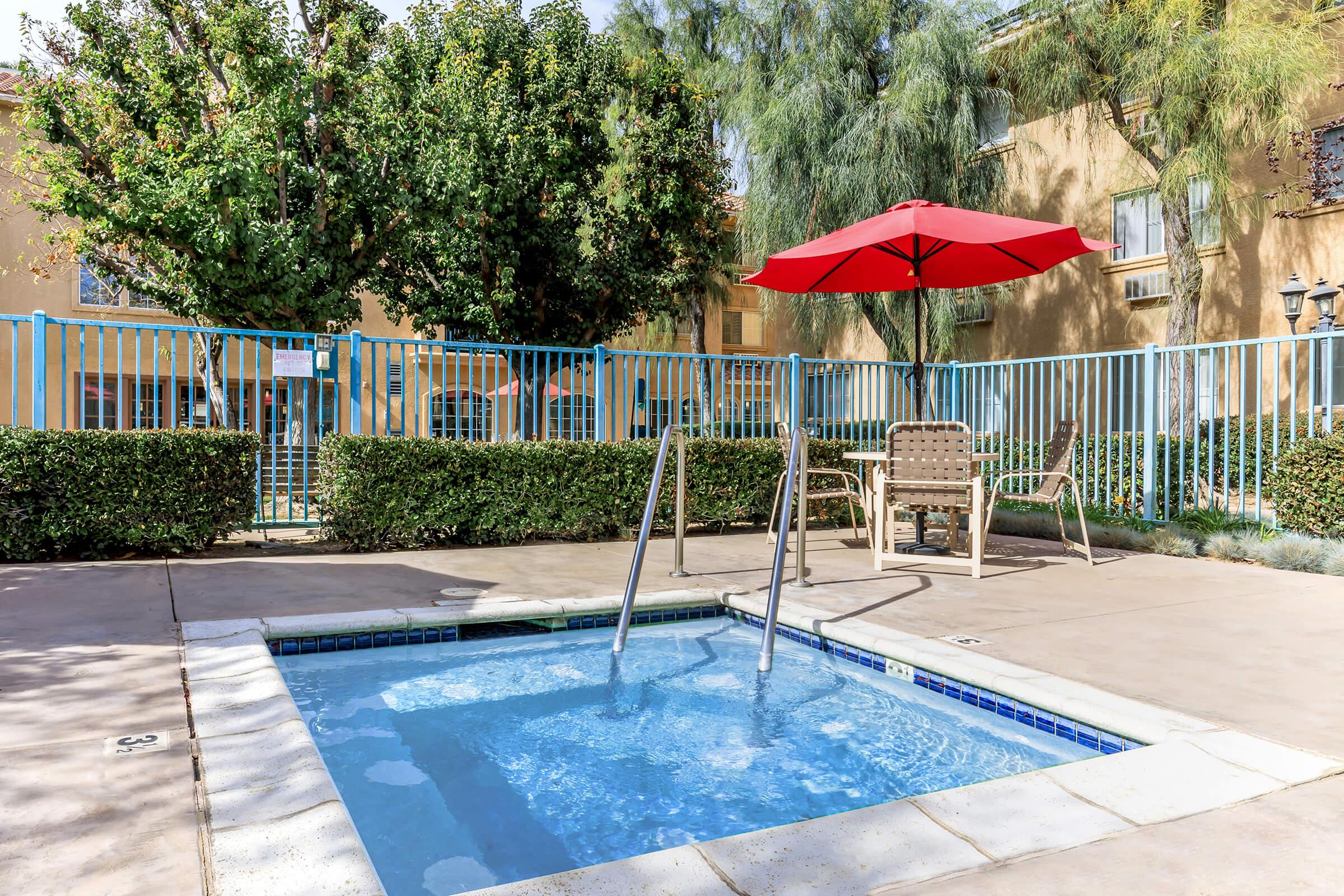 a table that has a umbrella in a pool