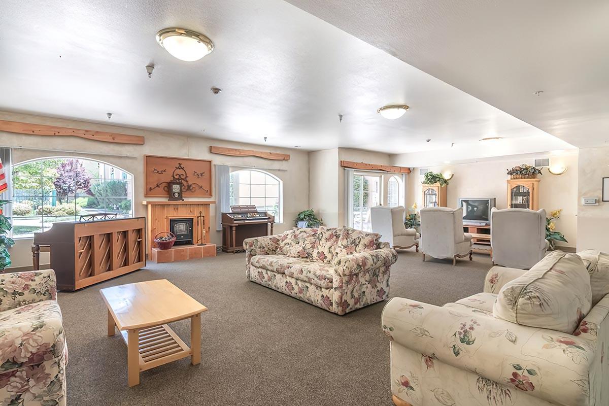 a living room filled with furniture and a bed