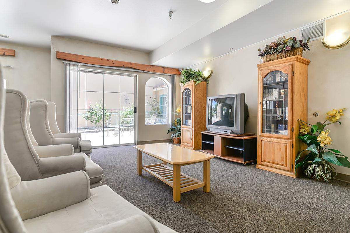 a living room filled with furniture and a large window