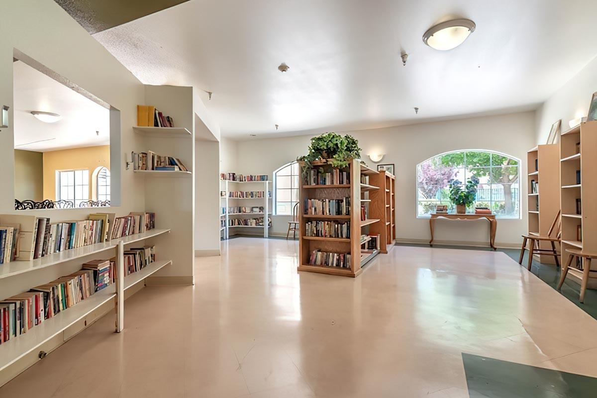 a living room filled with furniture and a book shelf