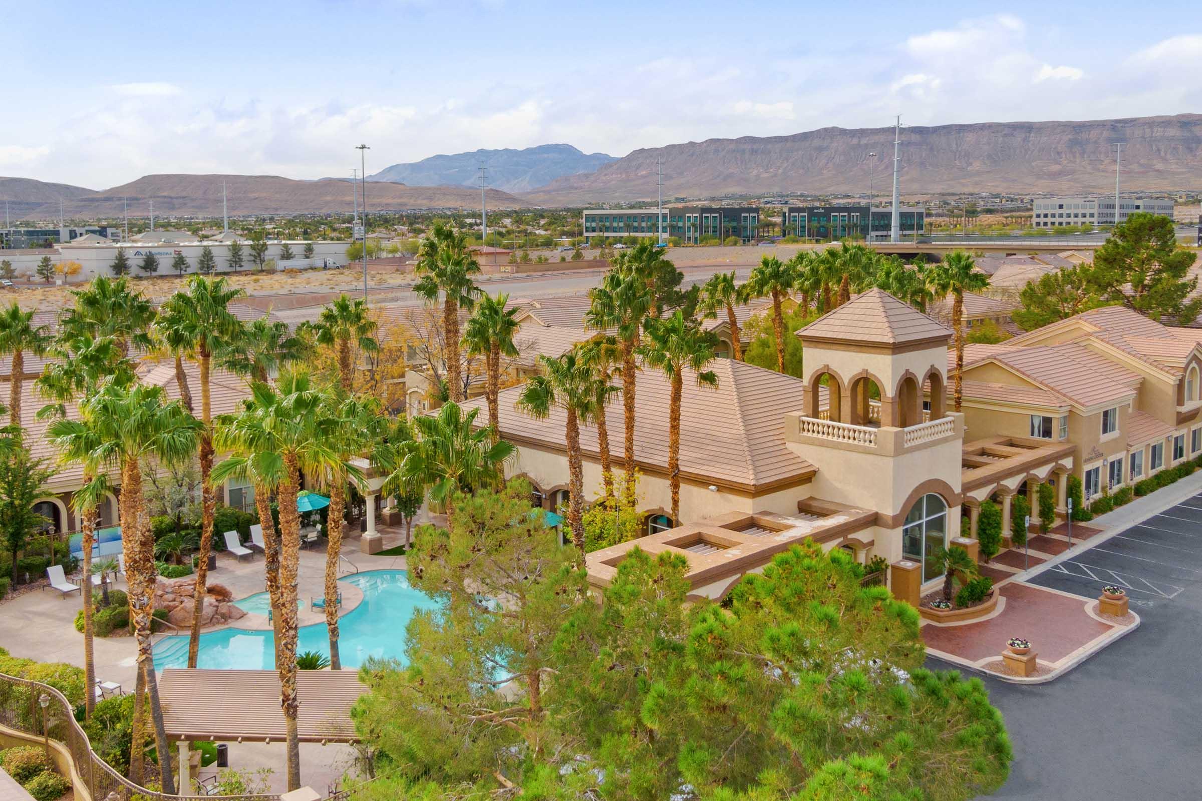 aerial view of clubhouse exterior and pool