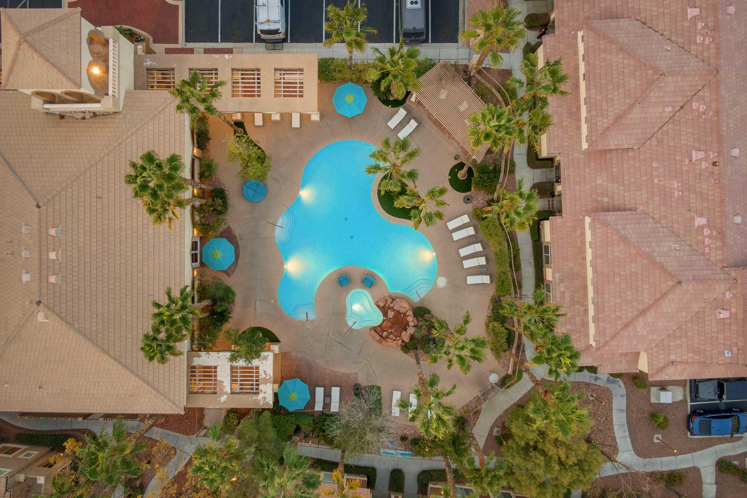 aerial view of lighted pool at dusk