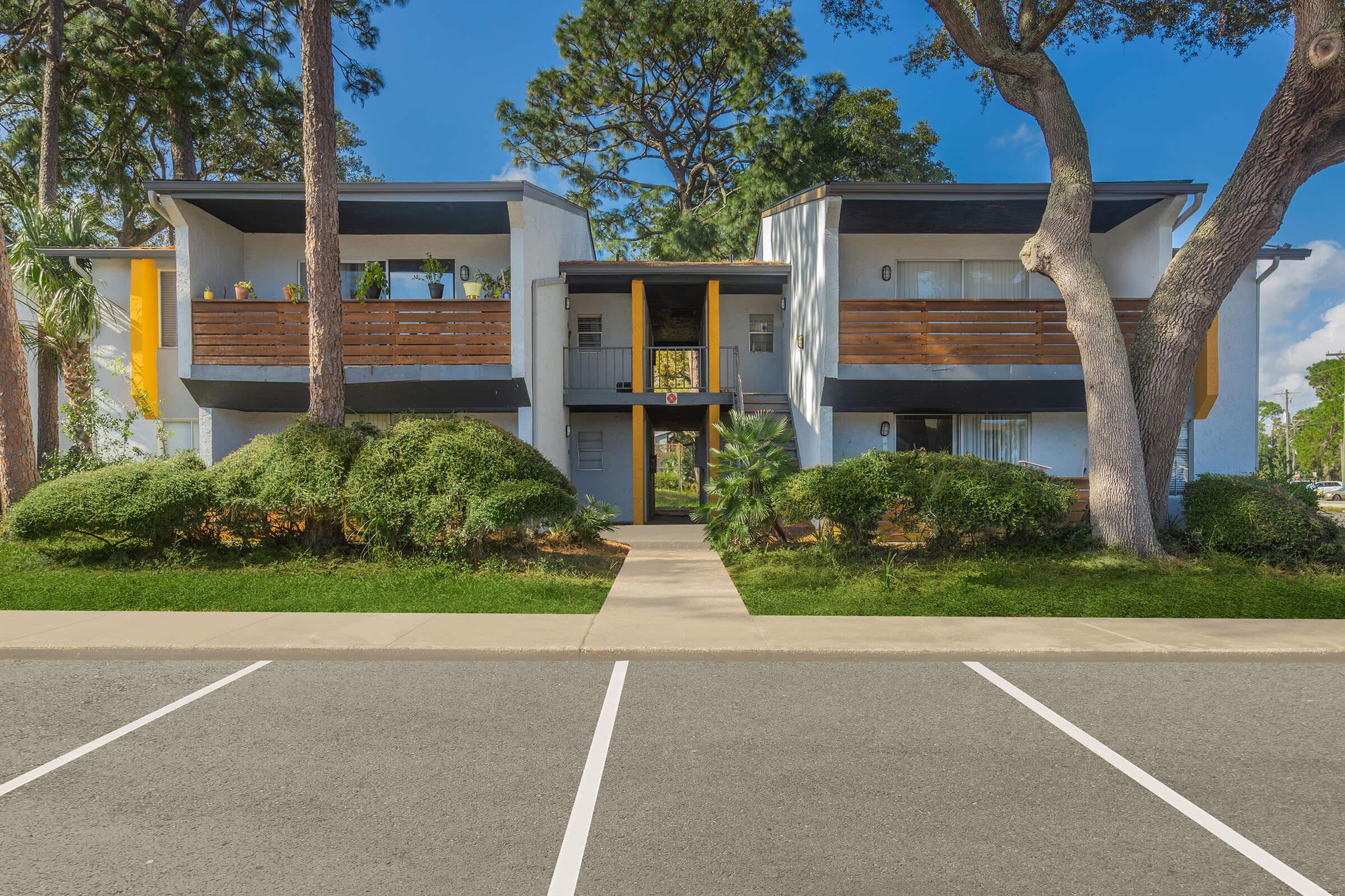 an empty parking lot in front of a house