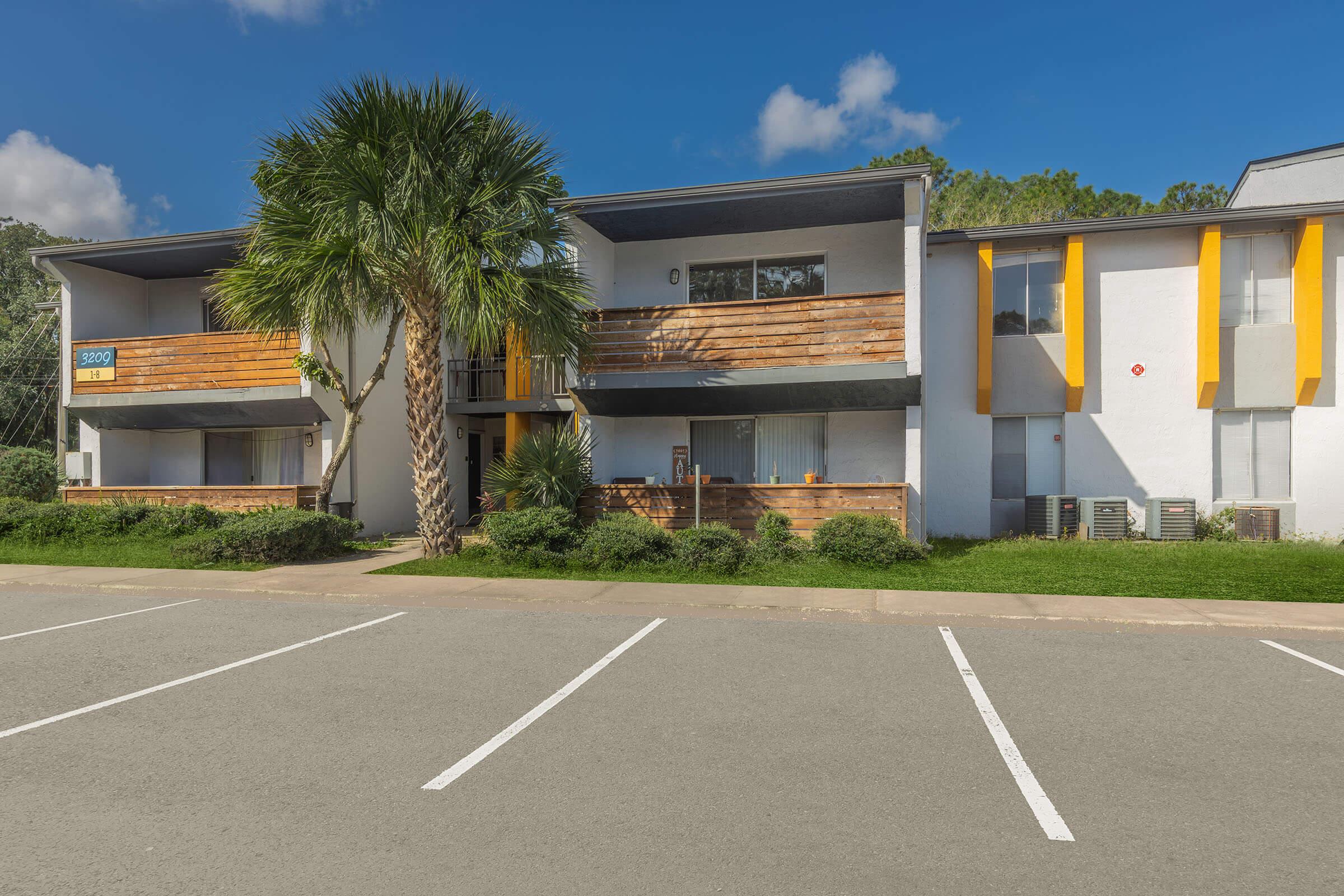 an empty parking lot in front of a house