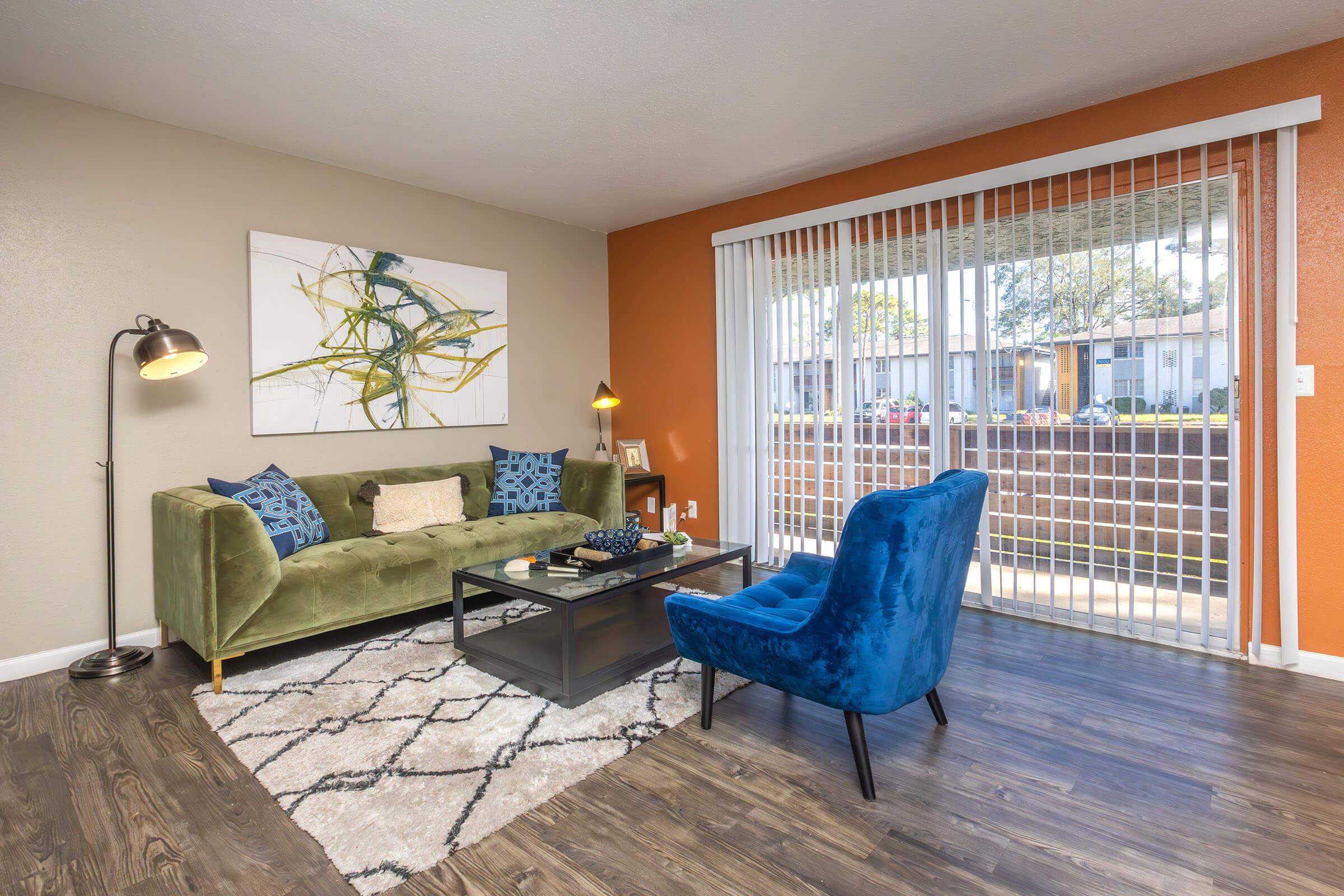 a living room filled with furniture and a large window