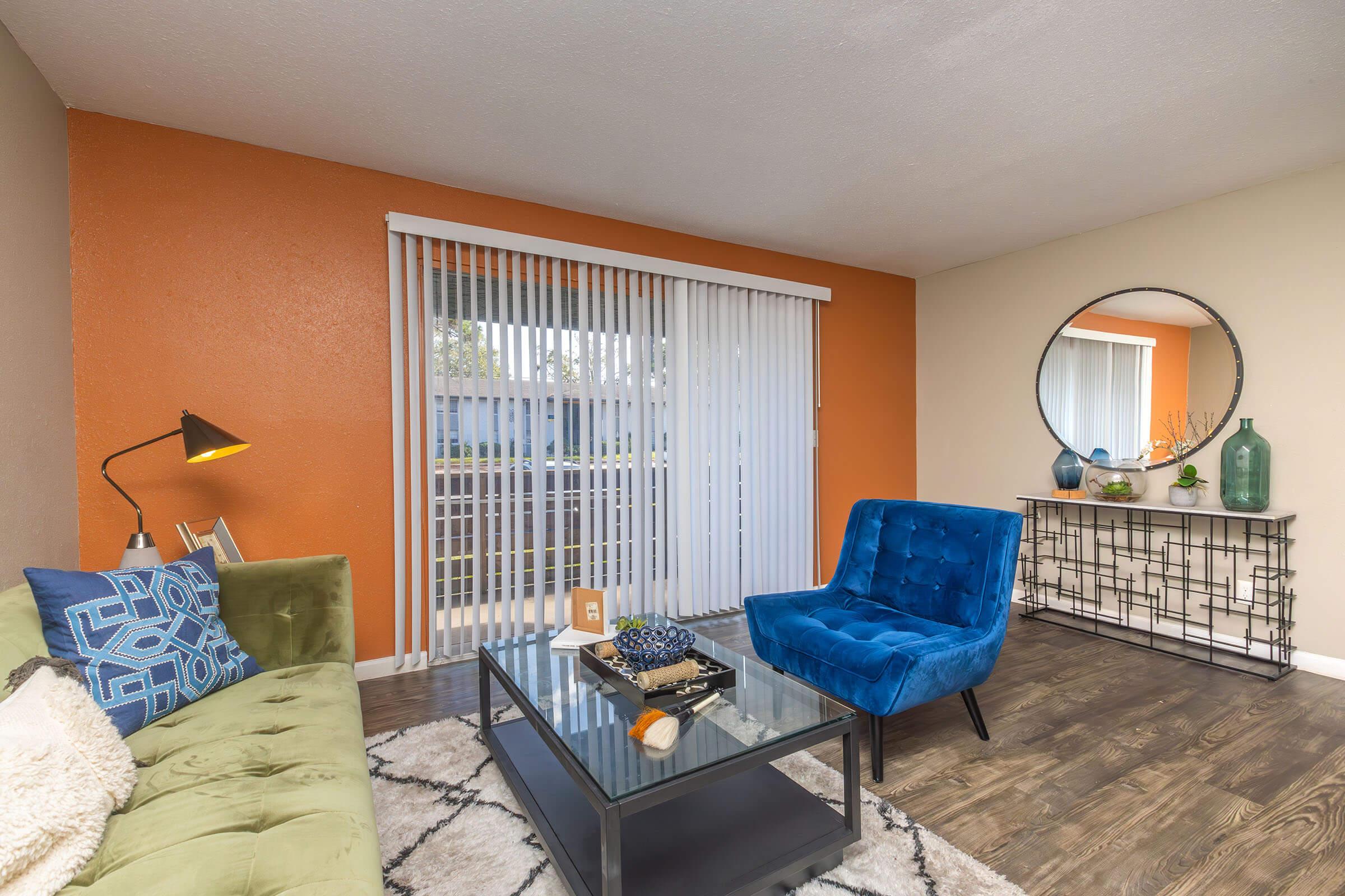 a living room filled with furniture and a blue chair