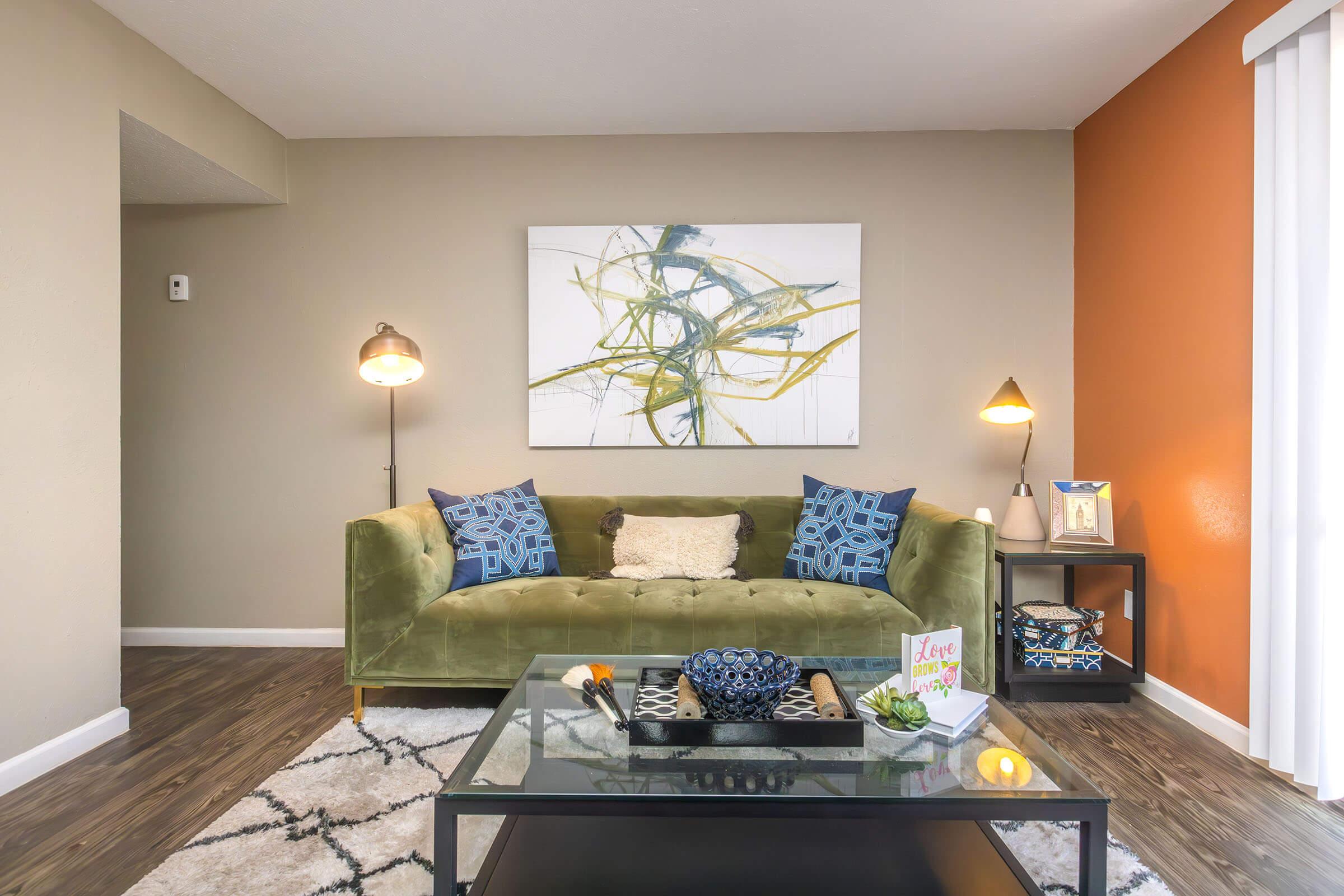 a living room filled with furniture and a lamp