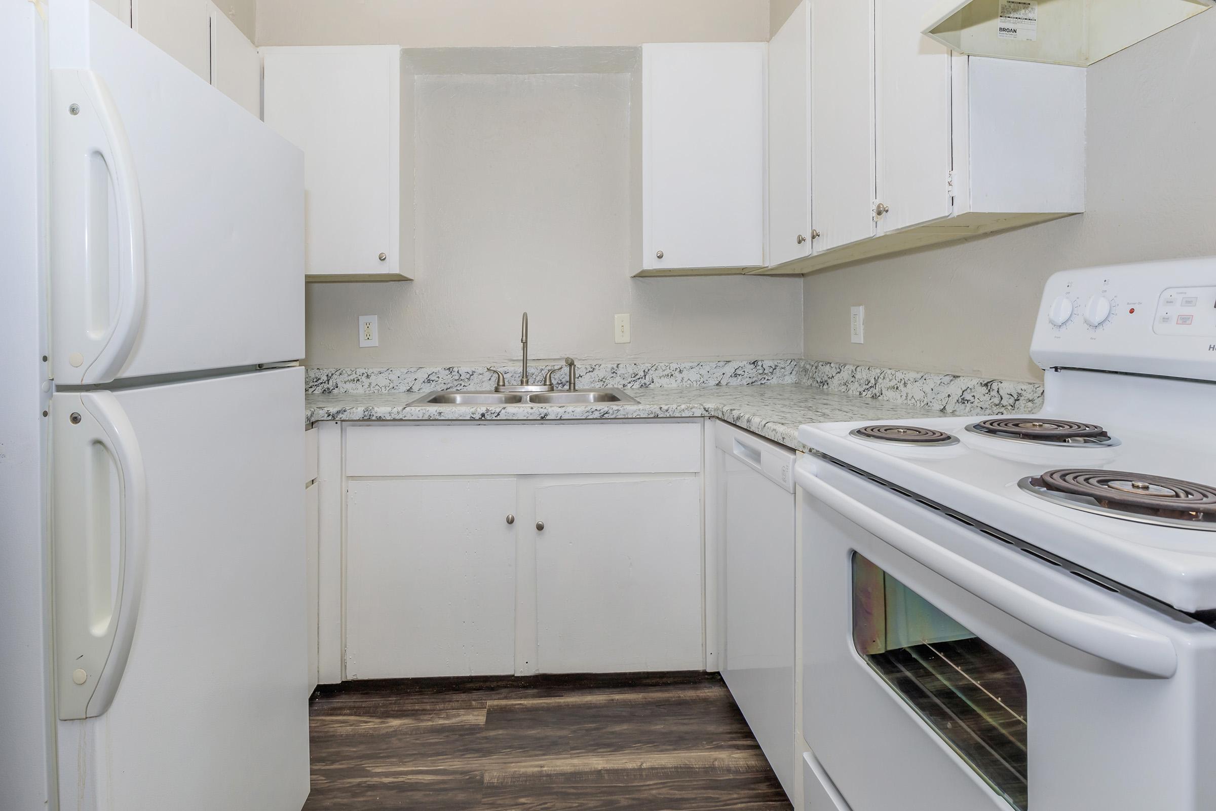 a stove top oven sitting inside of a kitchen