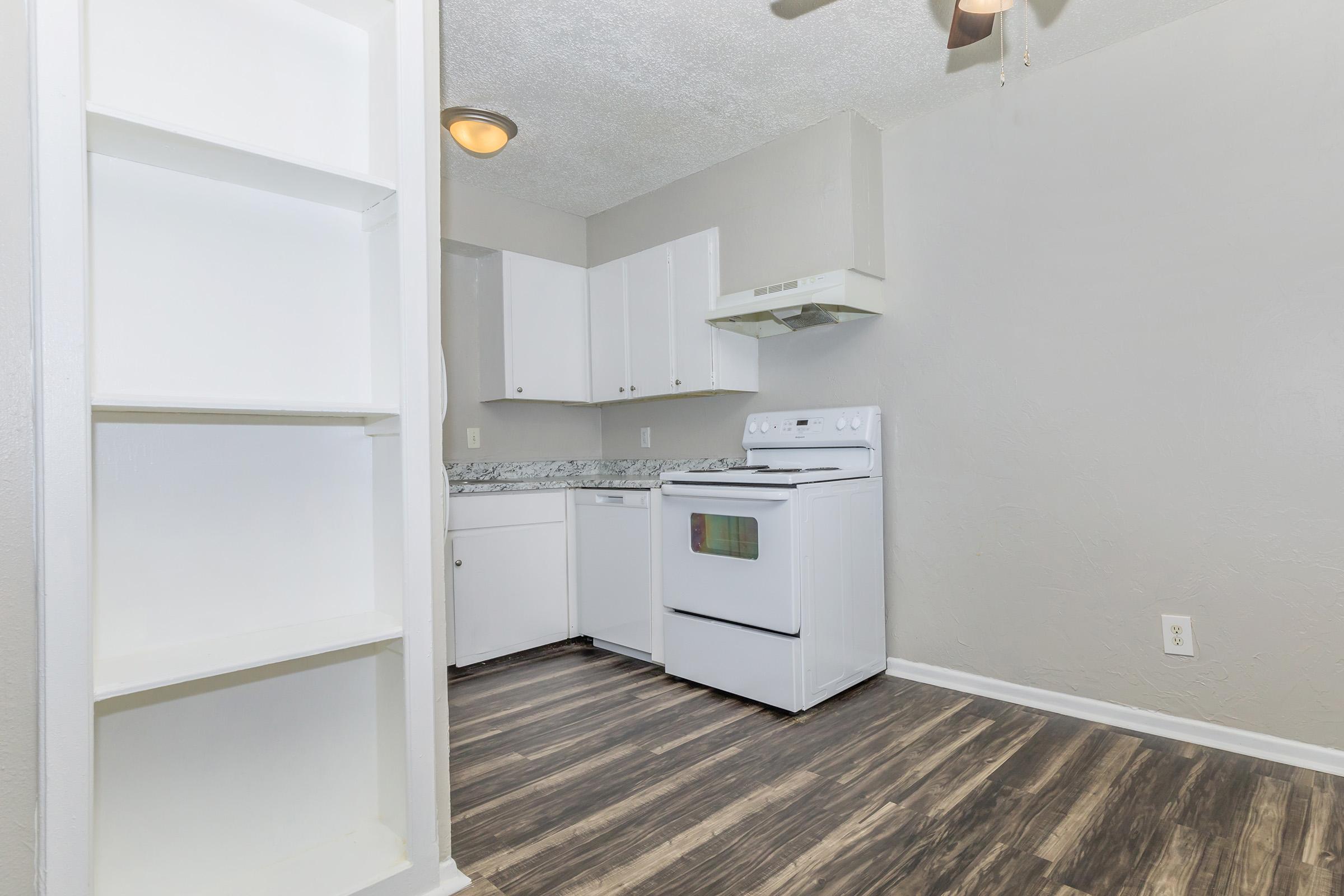 a kitchen with a stove and a refrigerator