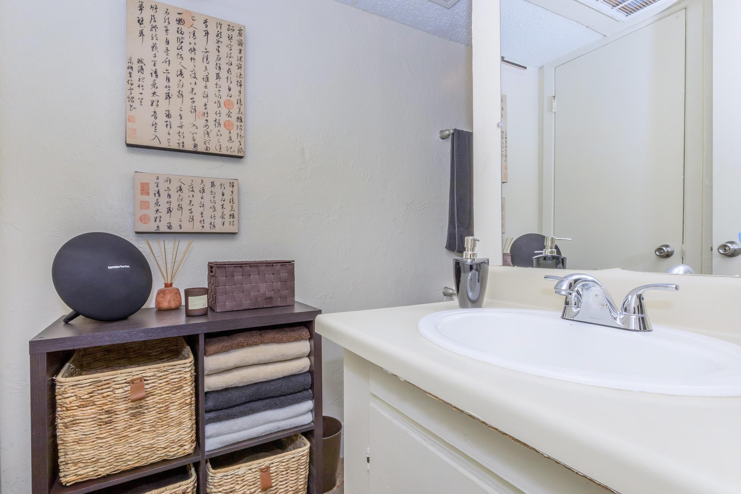 a room with a sink and a mirror