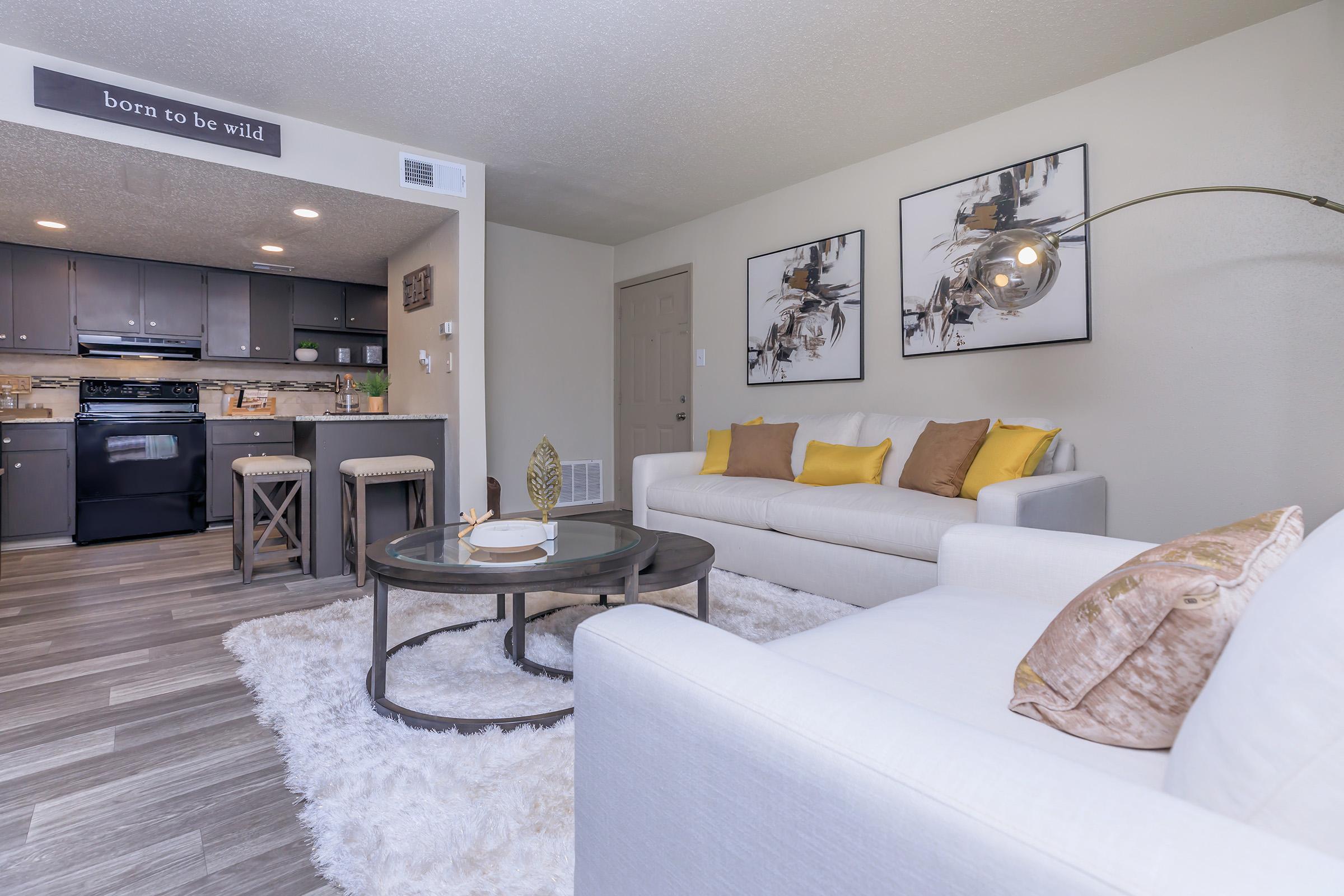 a living room filled with furniture and a flat screen tv