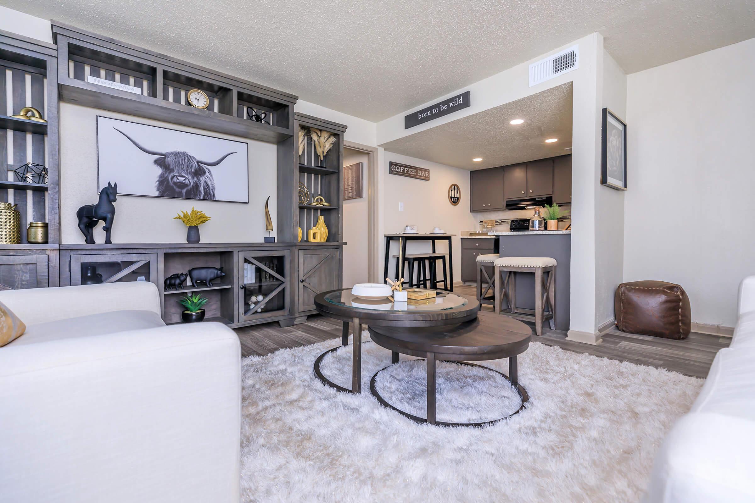 a living room filled with furniture and a table