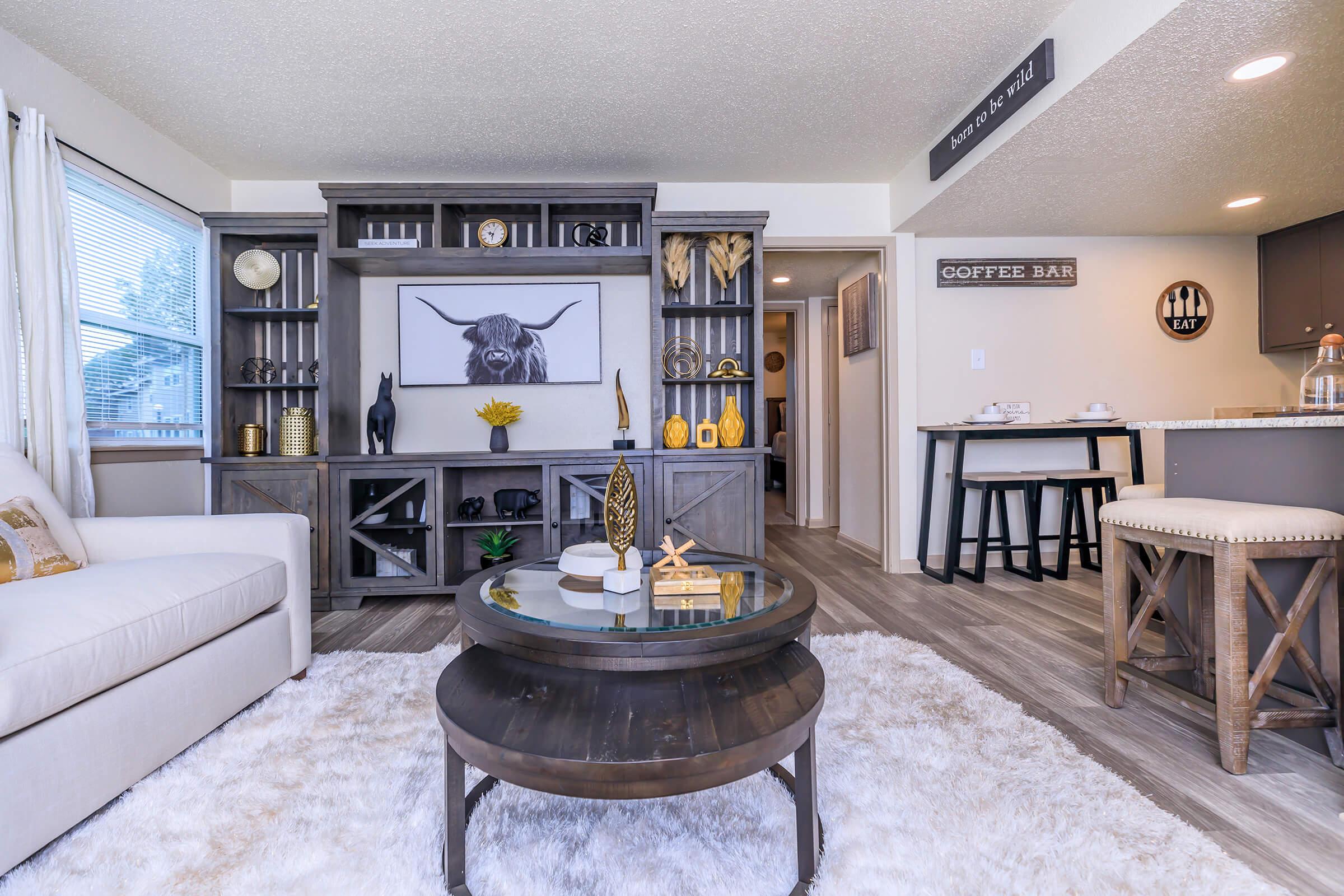 a living room filled with furniture and a flat screen tv