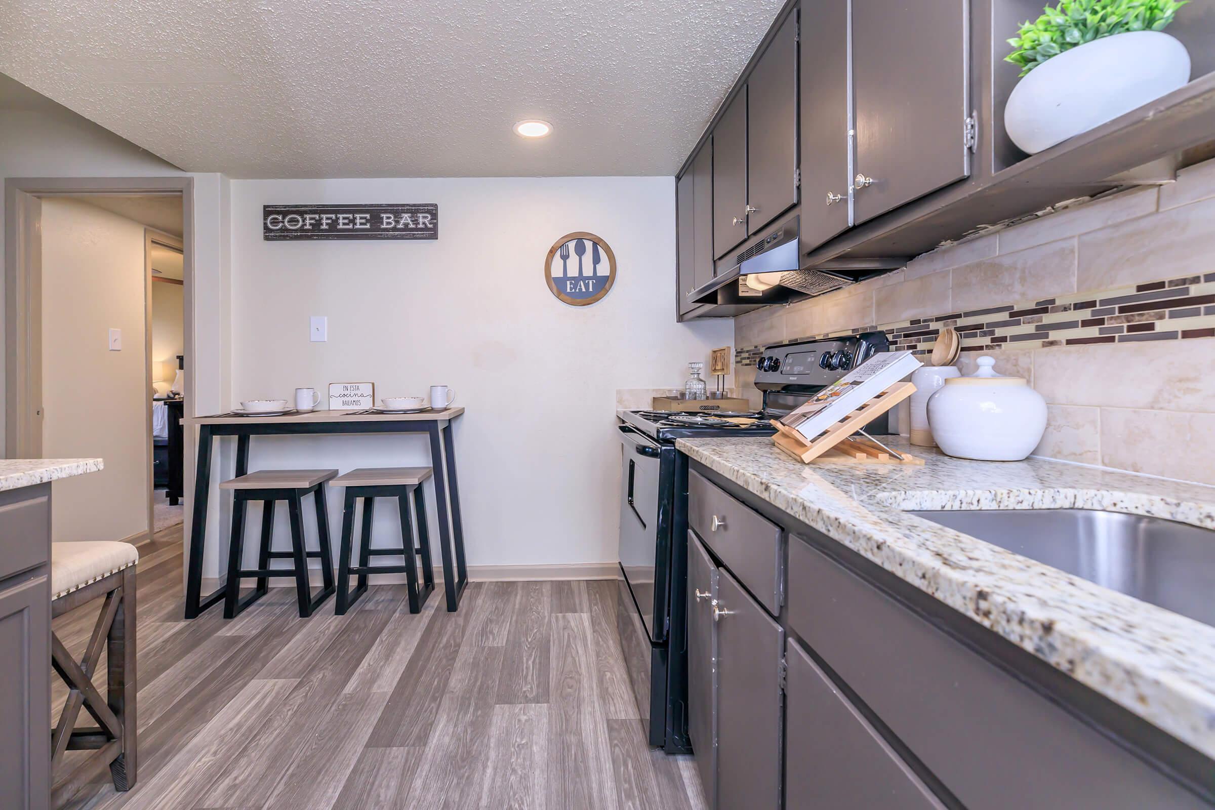 a kitchen with a sink and a counter in a room