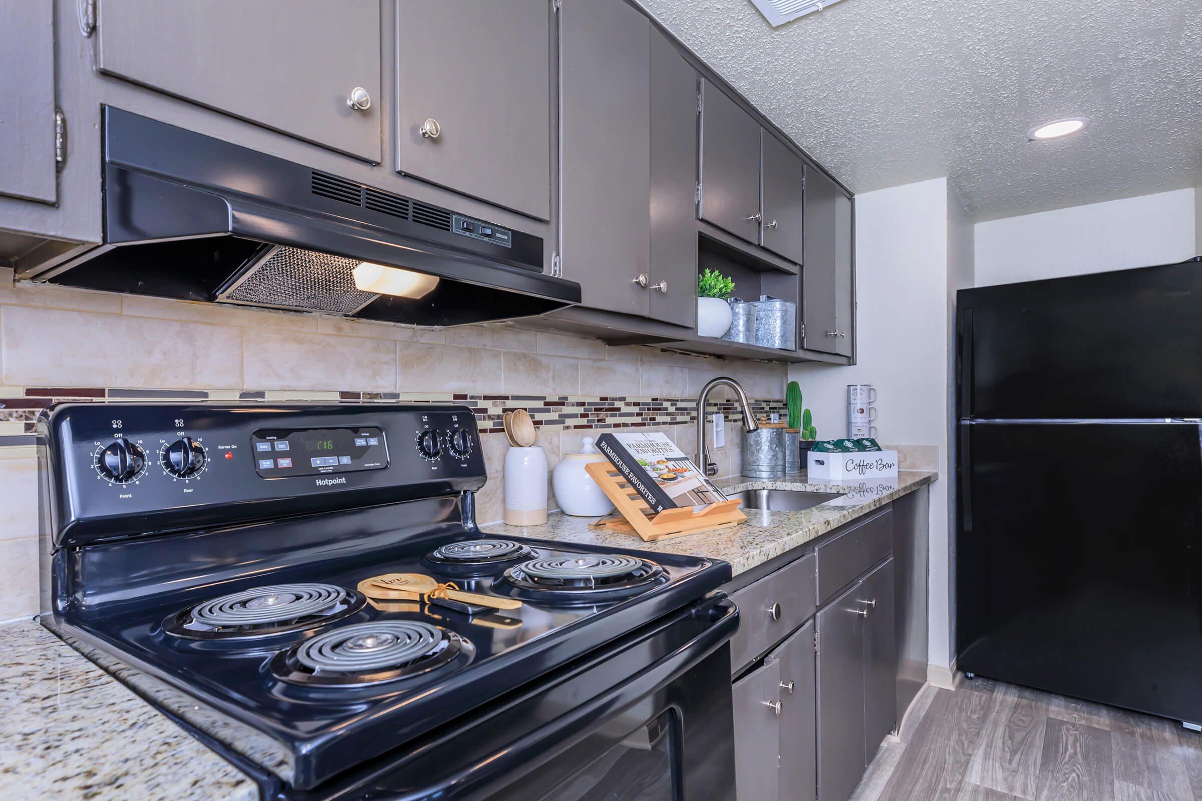 a stove top oven sitting inside of a kitchen