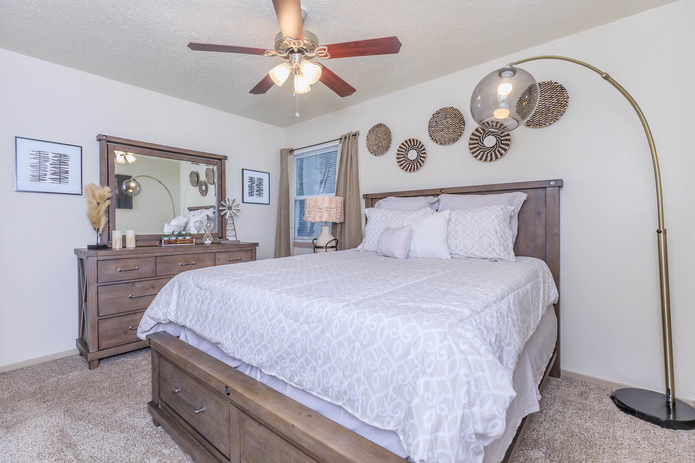 a bedroom with a bed and desk in a room